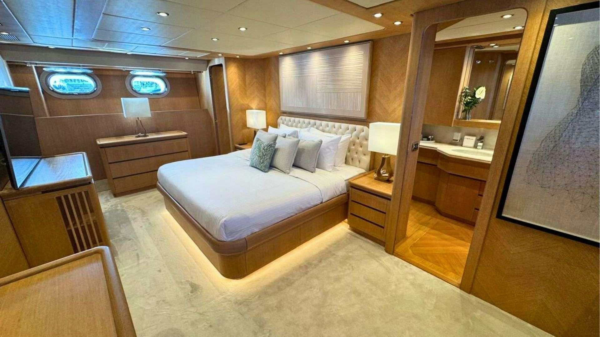 a room with a bed and a mirror aboard NOVA Yacht for Charter