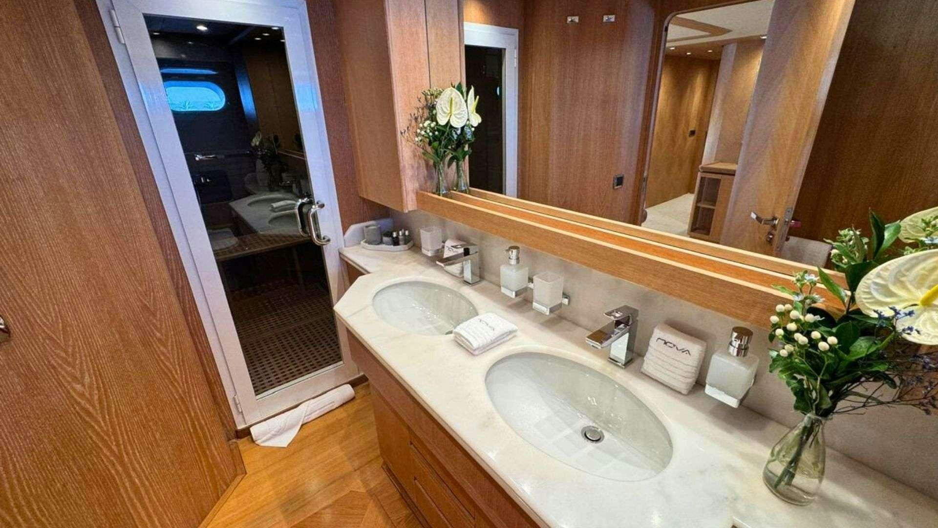 a bathroom with a sink and a mirror aboard NOVA Yacht for Charter