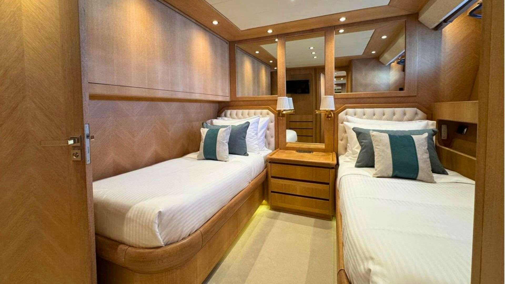 a room with two beds aboard NOVA Yacht for Charter