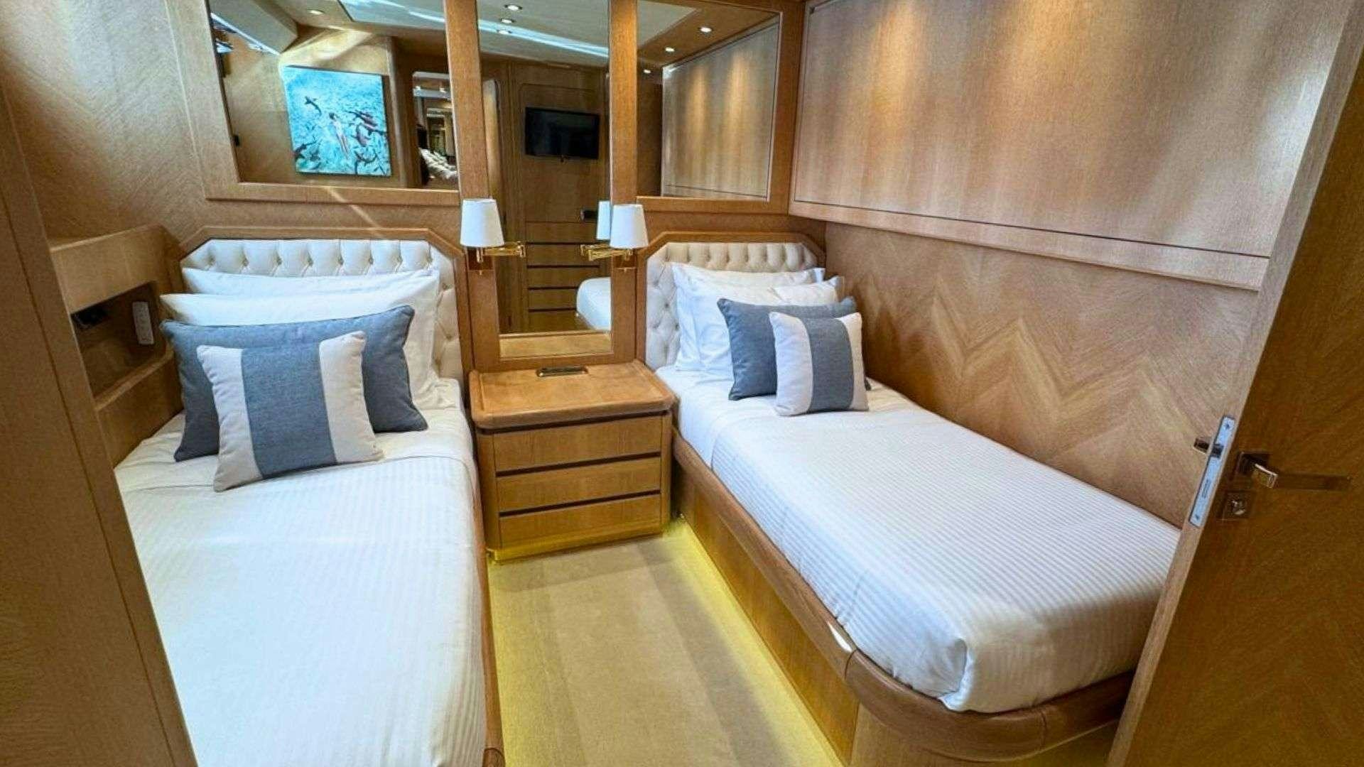 a room with two beds aboard NOVA Yacht for Charter