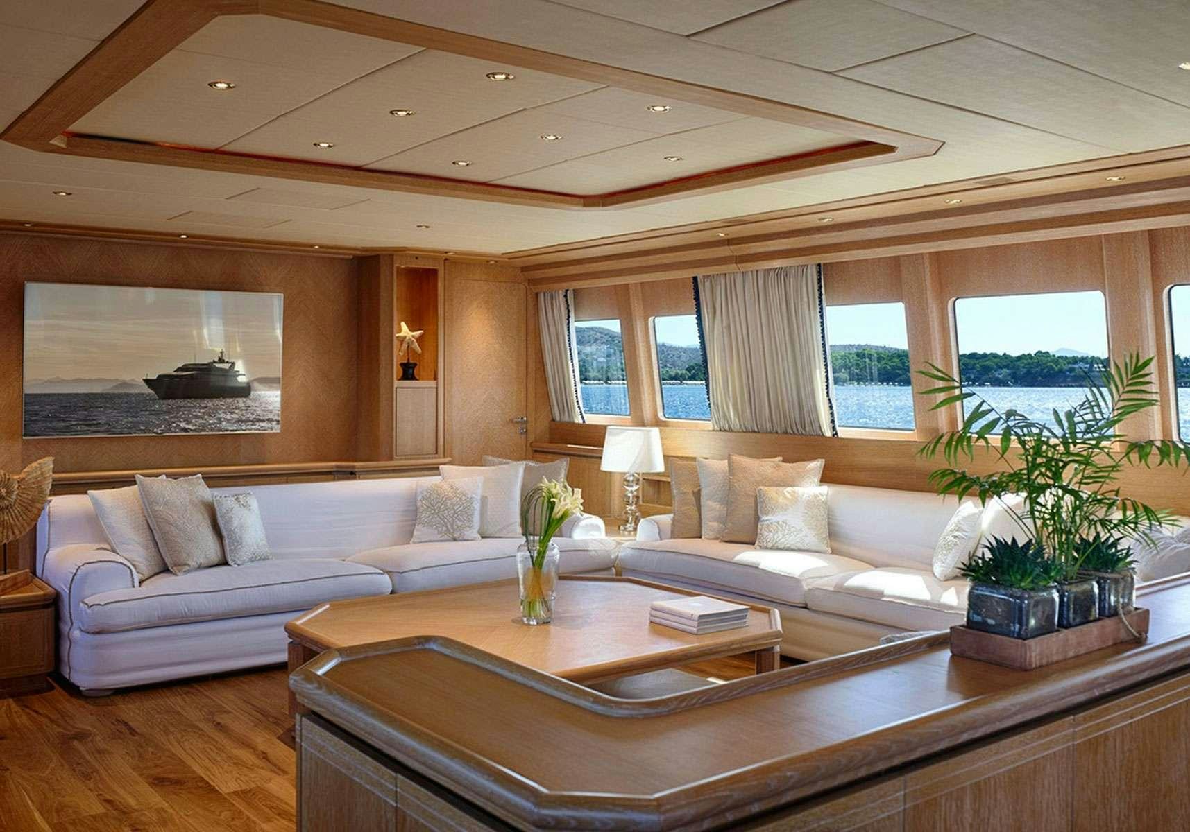 a living room with a large sofa aboard NOVA Yacht for Charter
