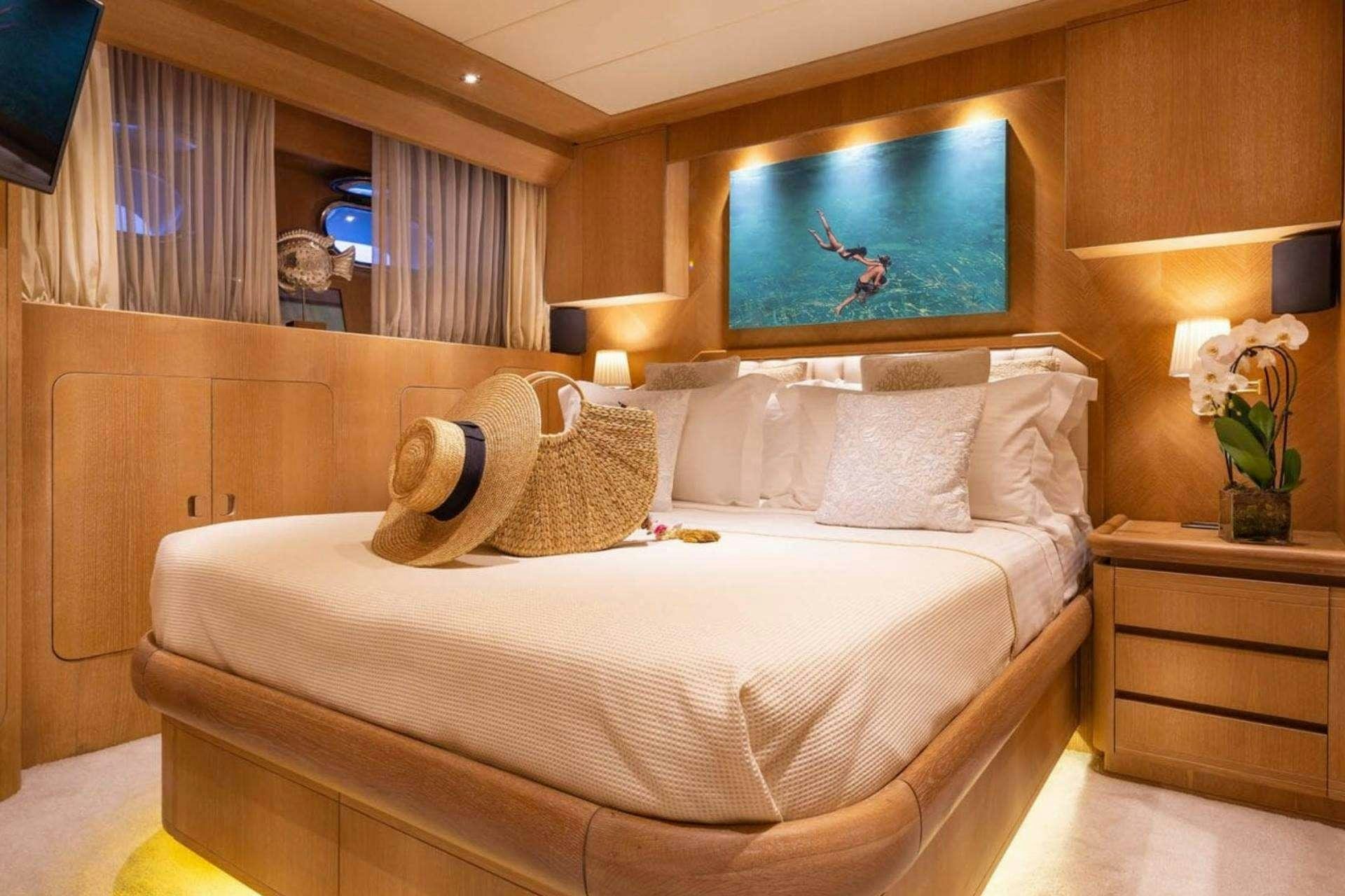 a bed with pillows and pillows aboard NOVA Yacht for Charter