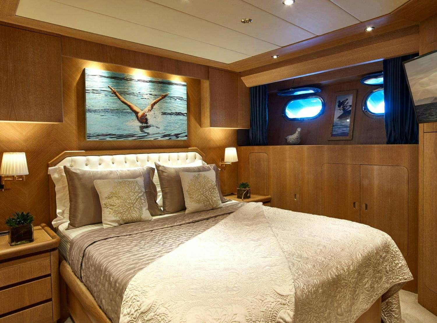 a bed with a large bed aboard NOVA Yacht for Charter