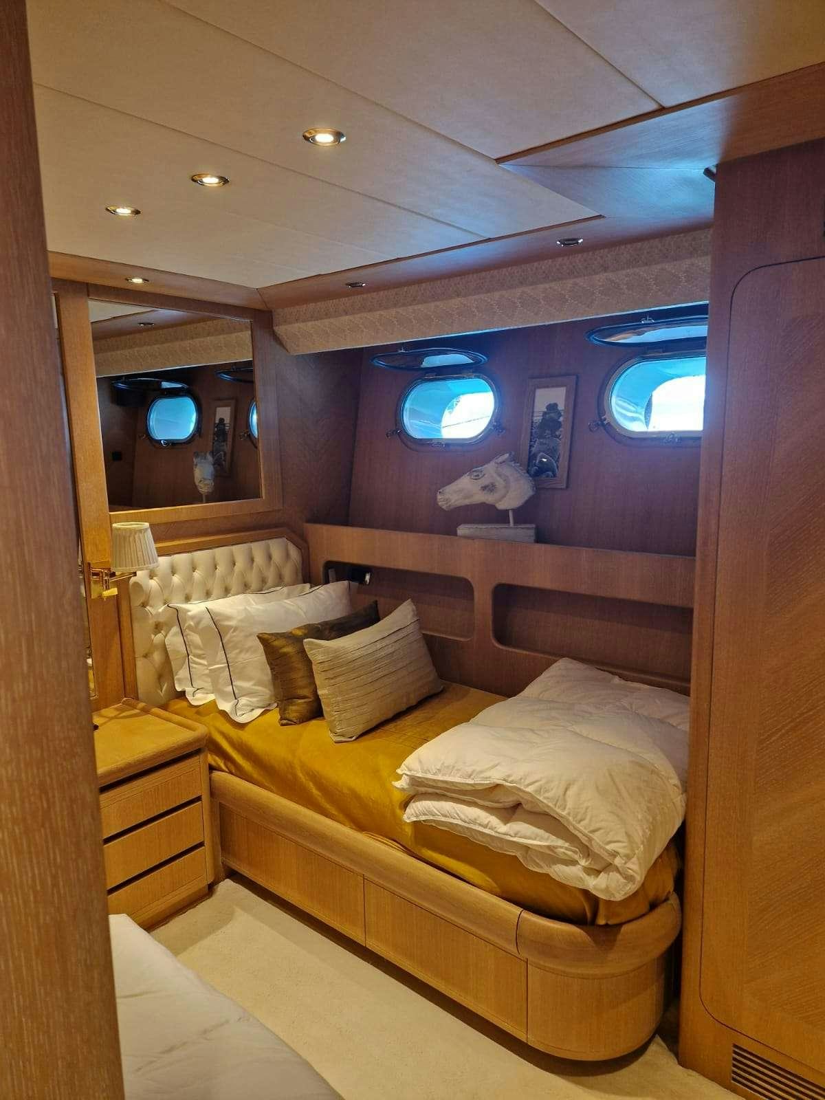a room with a bed and a mirror aboard NOVA Yacht for Charter