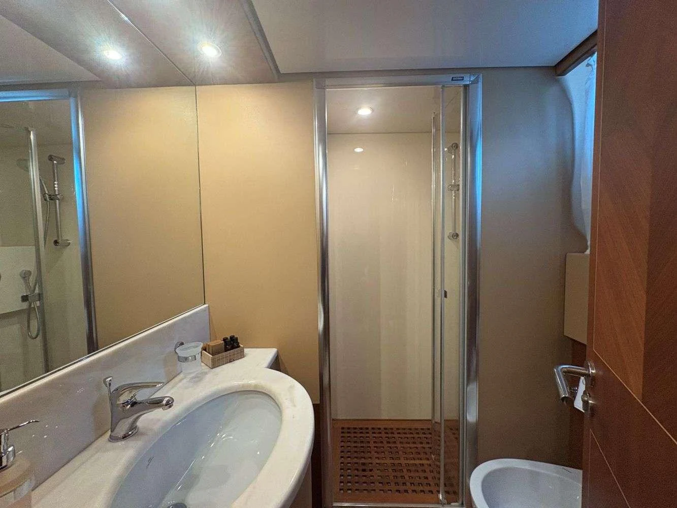 a bathroom with a glass shower door aboard MAMMA'S Yacht for Charter