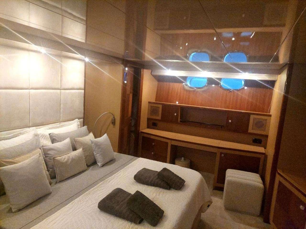 a room with a bed and a piano aboard MAMMA'S Yacht for Charter