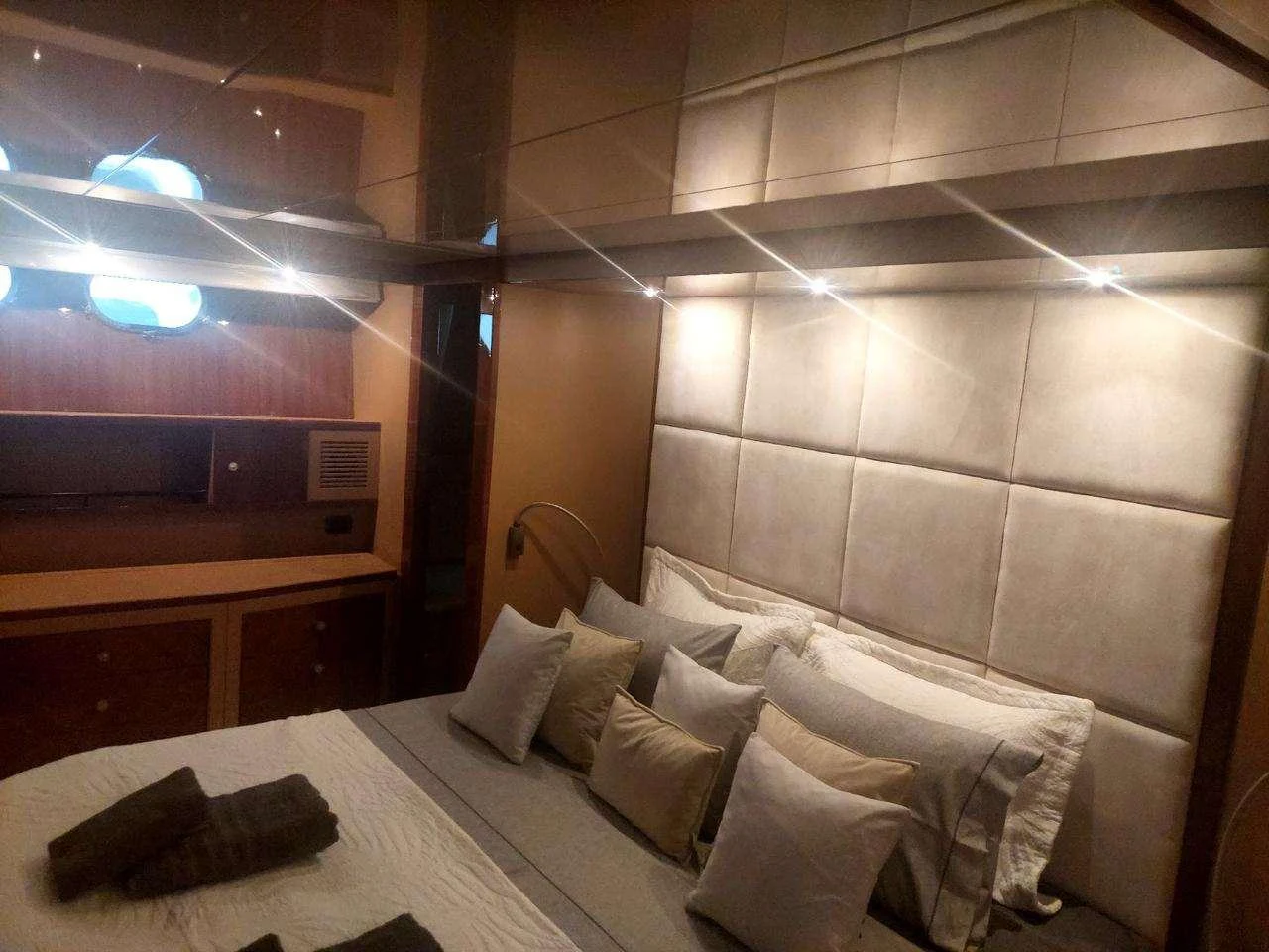a bed with white pillows aboard MAMMA'S Yacht for Charter