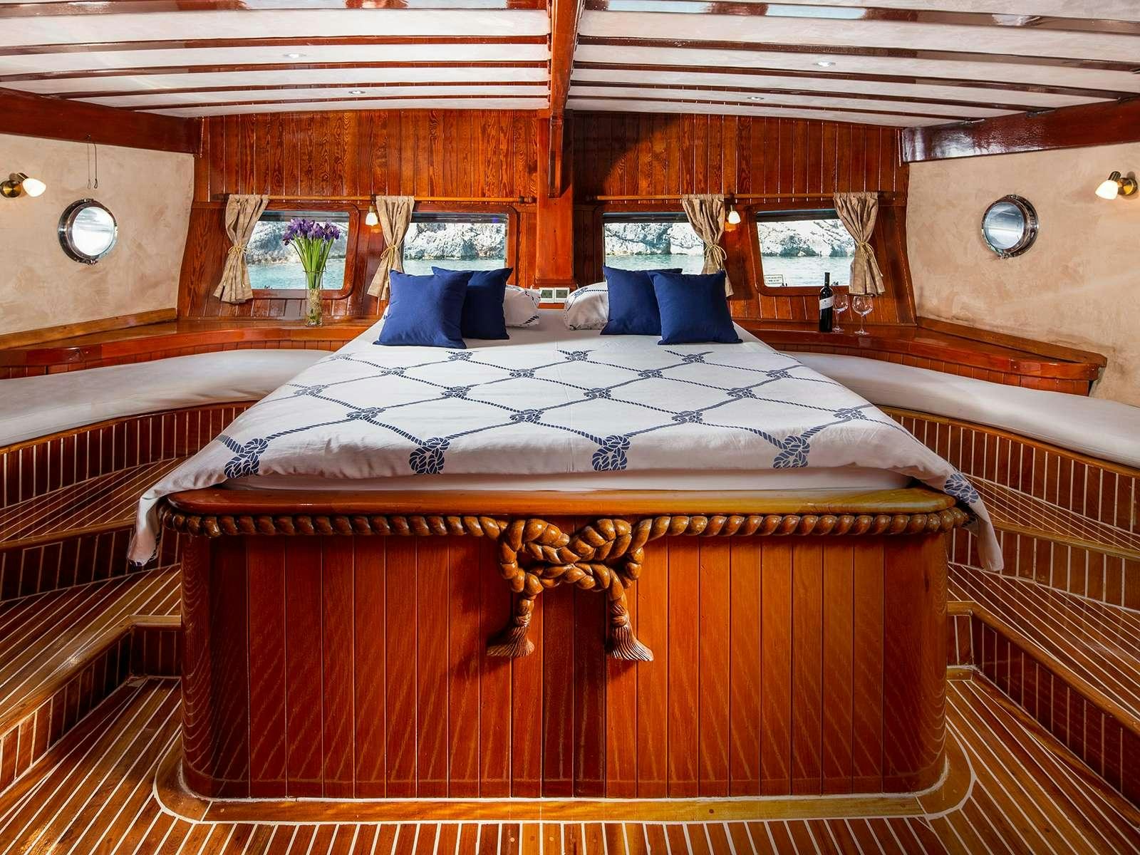 a bed with a wooden canopy aboard ELEGANZA Yacht for Charter