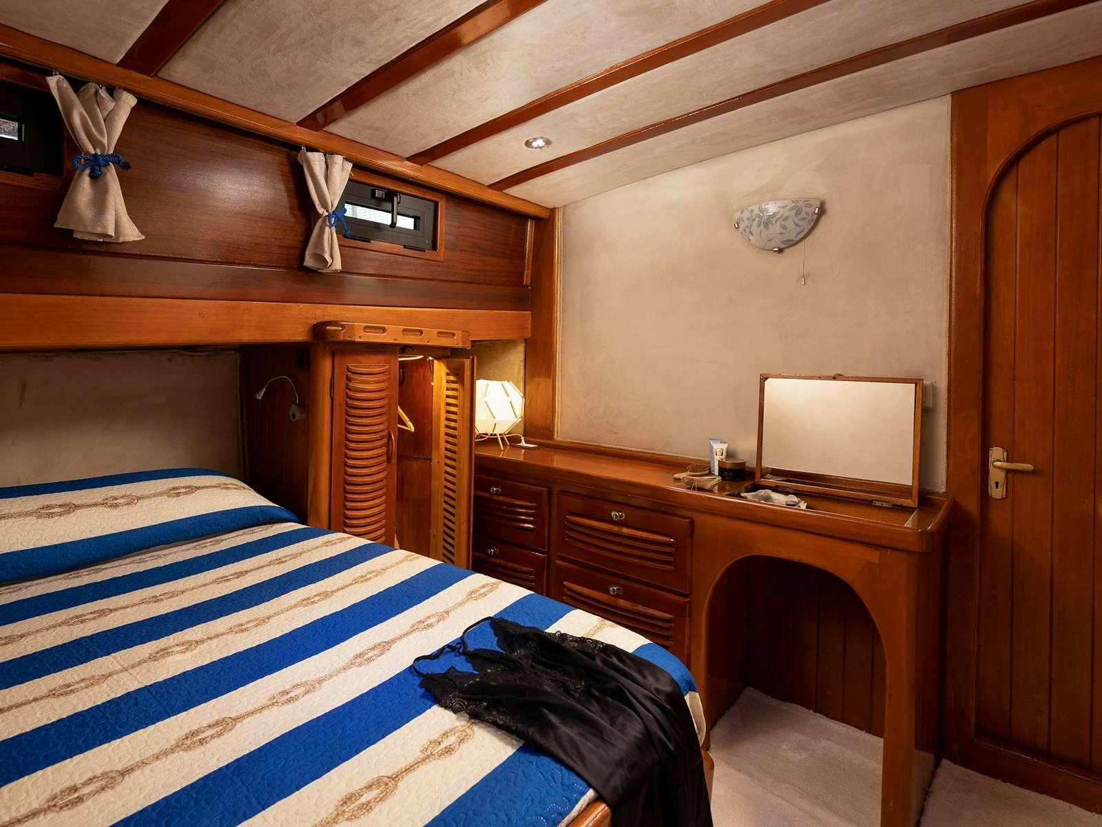 a bedroom with a desk and a computer aboard ELEGANZA Yacht for Charter