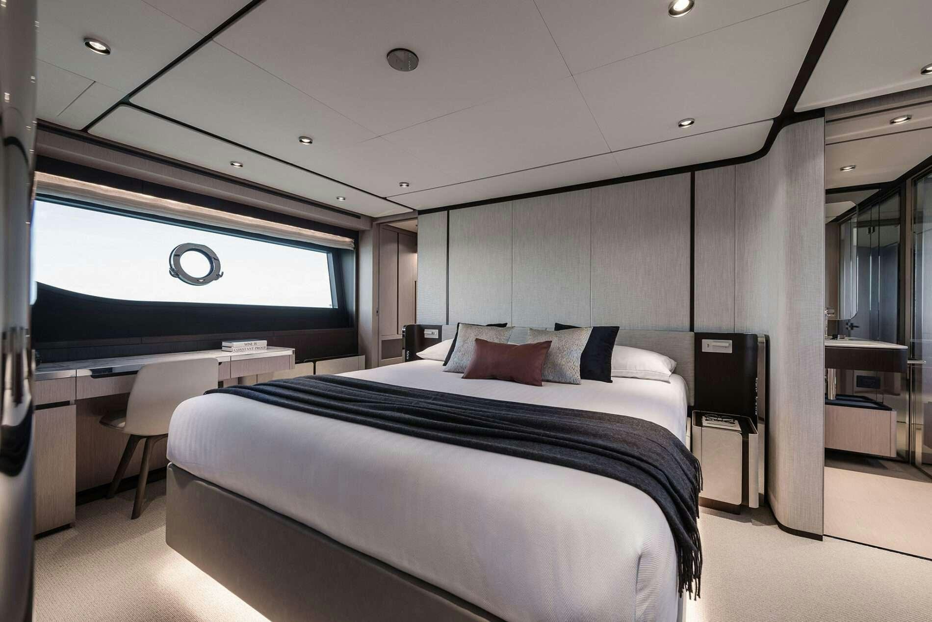 a room with a bed and a tv aboard FAST Yacht for Charter