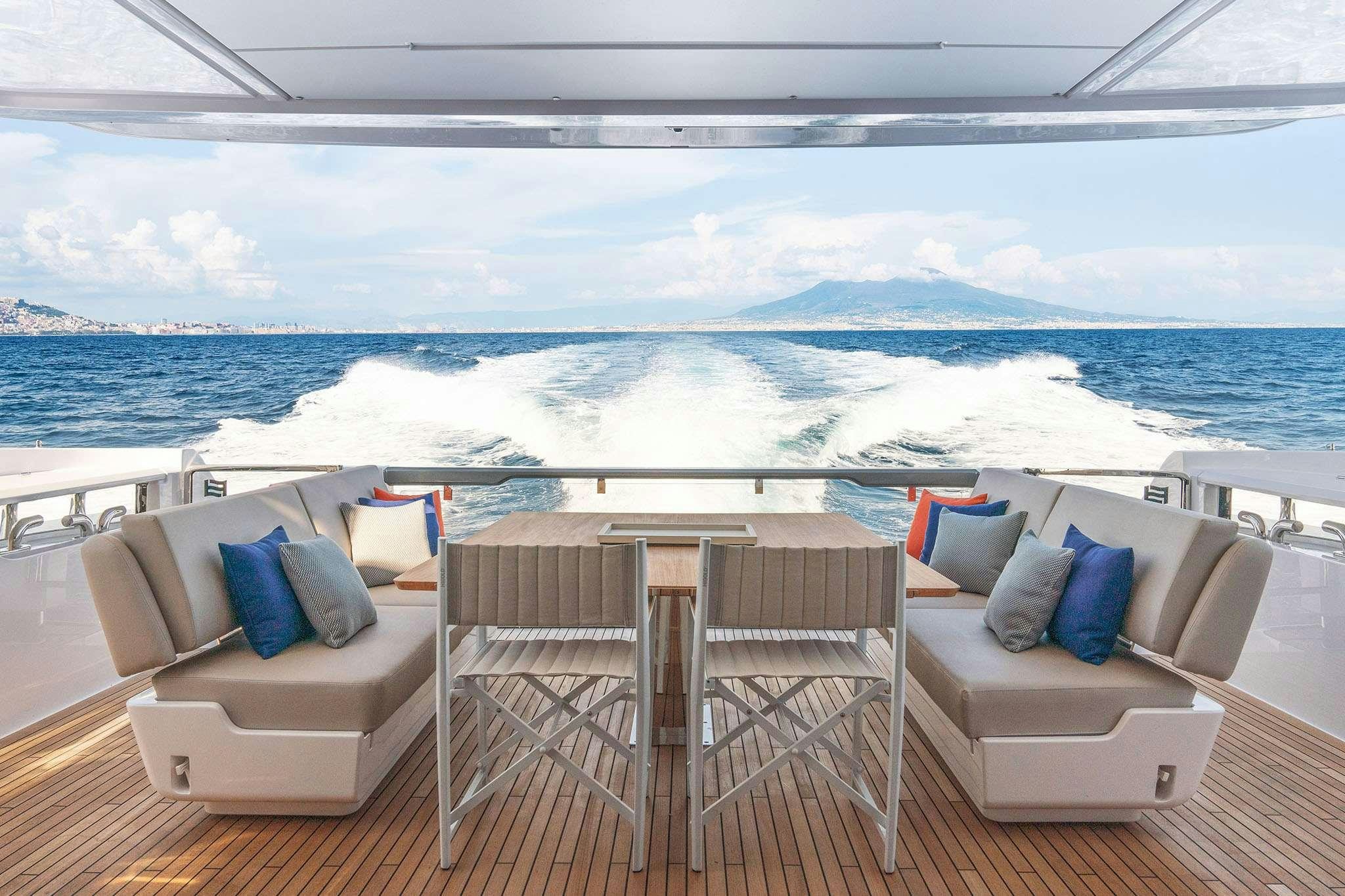a room with chairs and a view of the ocean aboard FAST Yacht for Charter