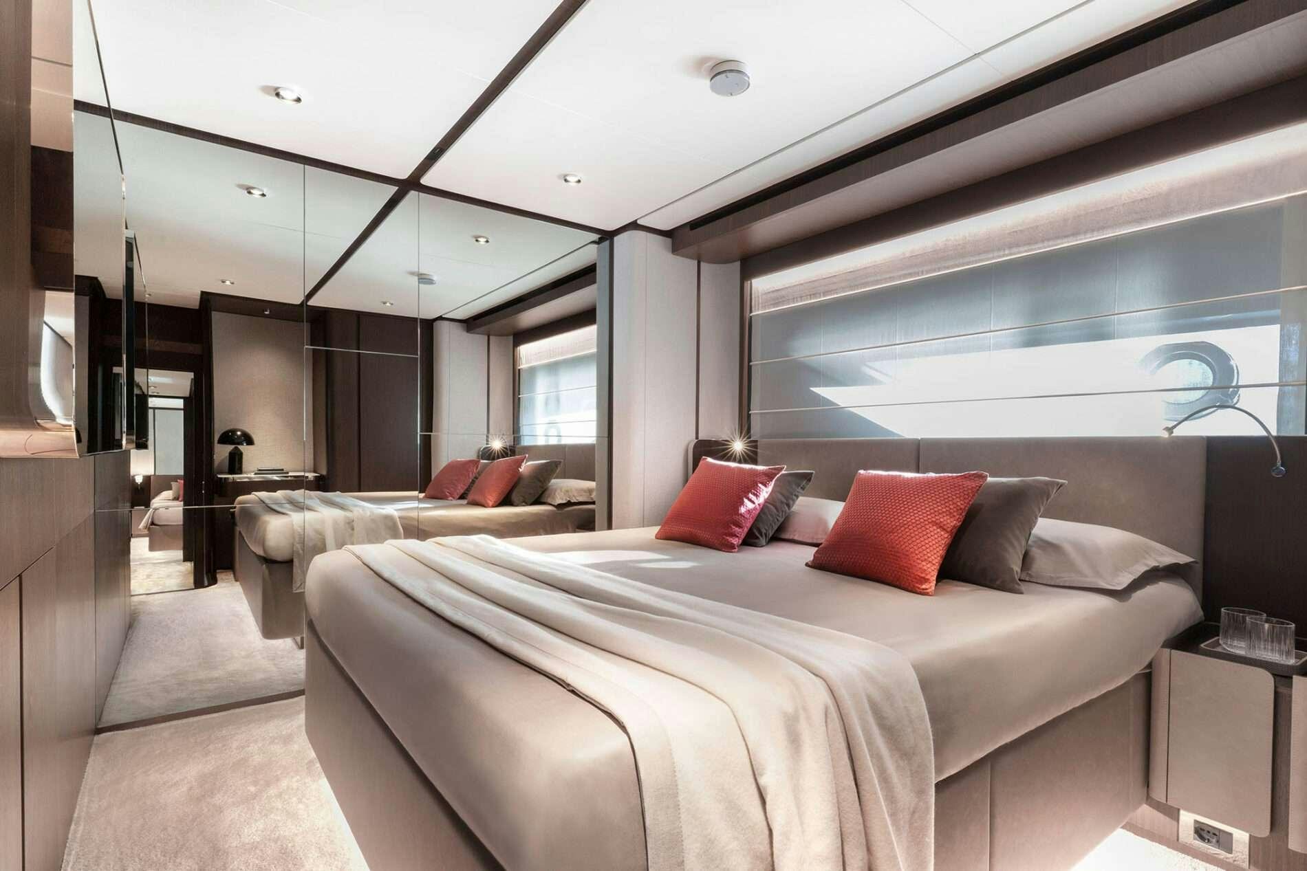 a room with a bed and a window aboard FAST Yacht for Charter
