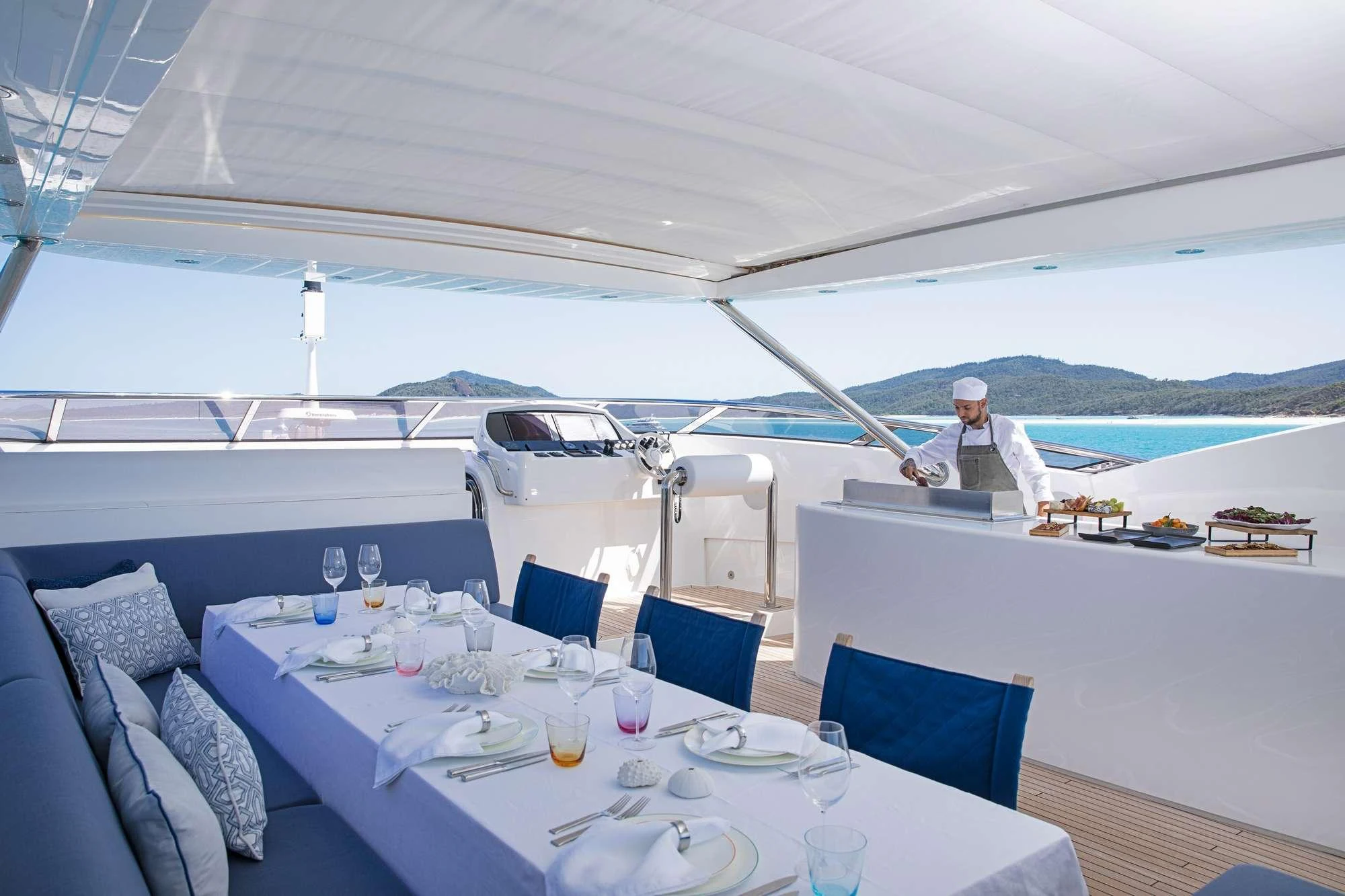 a person standing at a table aboard GEORGE P Yacht for Charter
