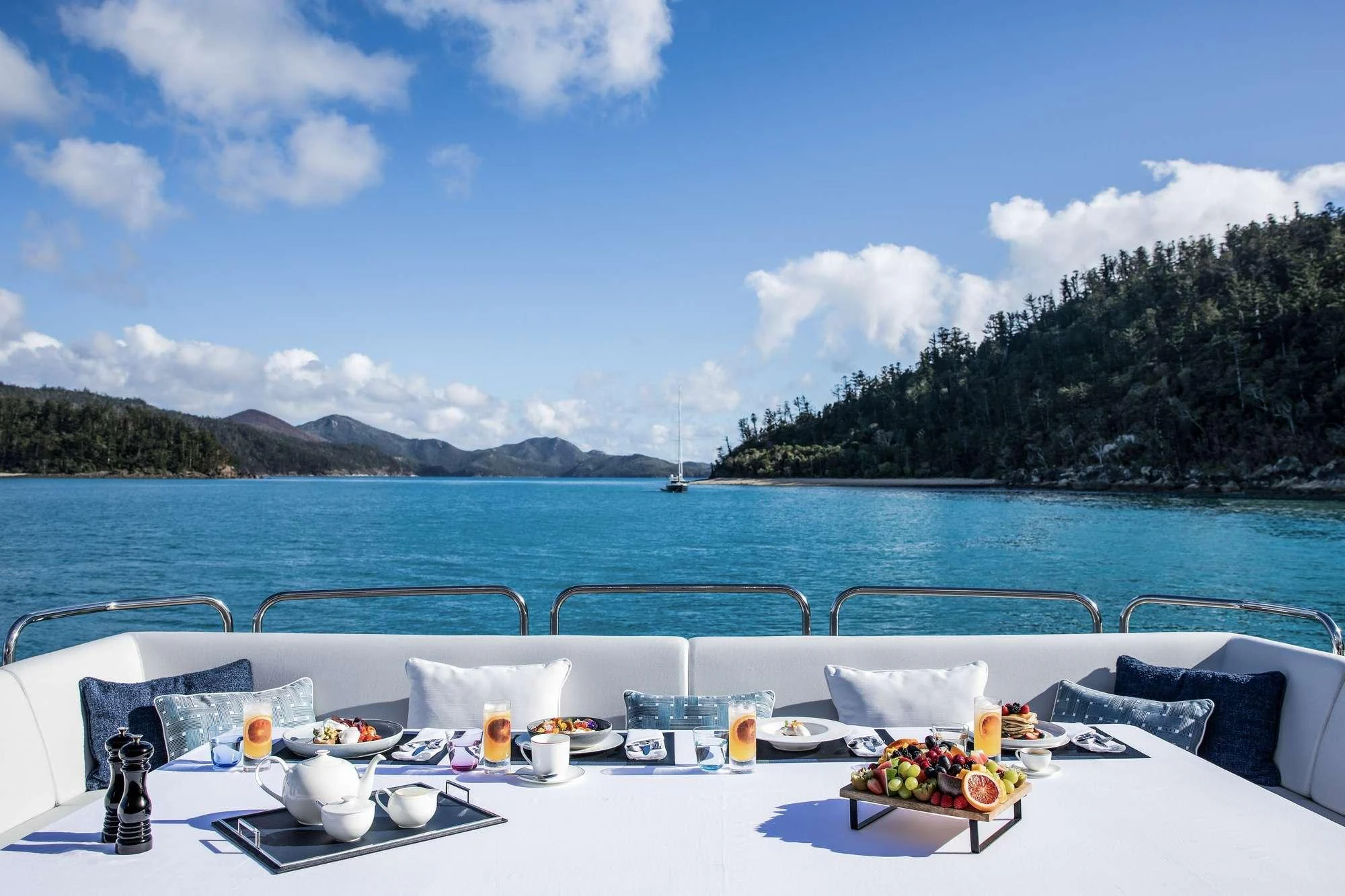 a table with food on it by the water aboard GEORGE P Yacht for Charter