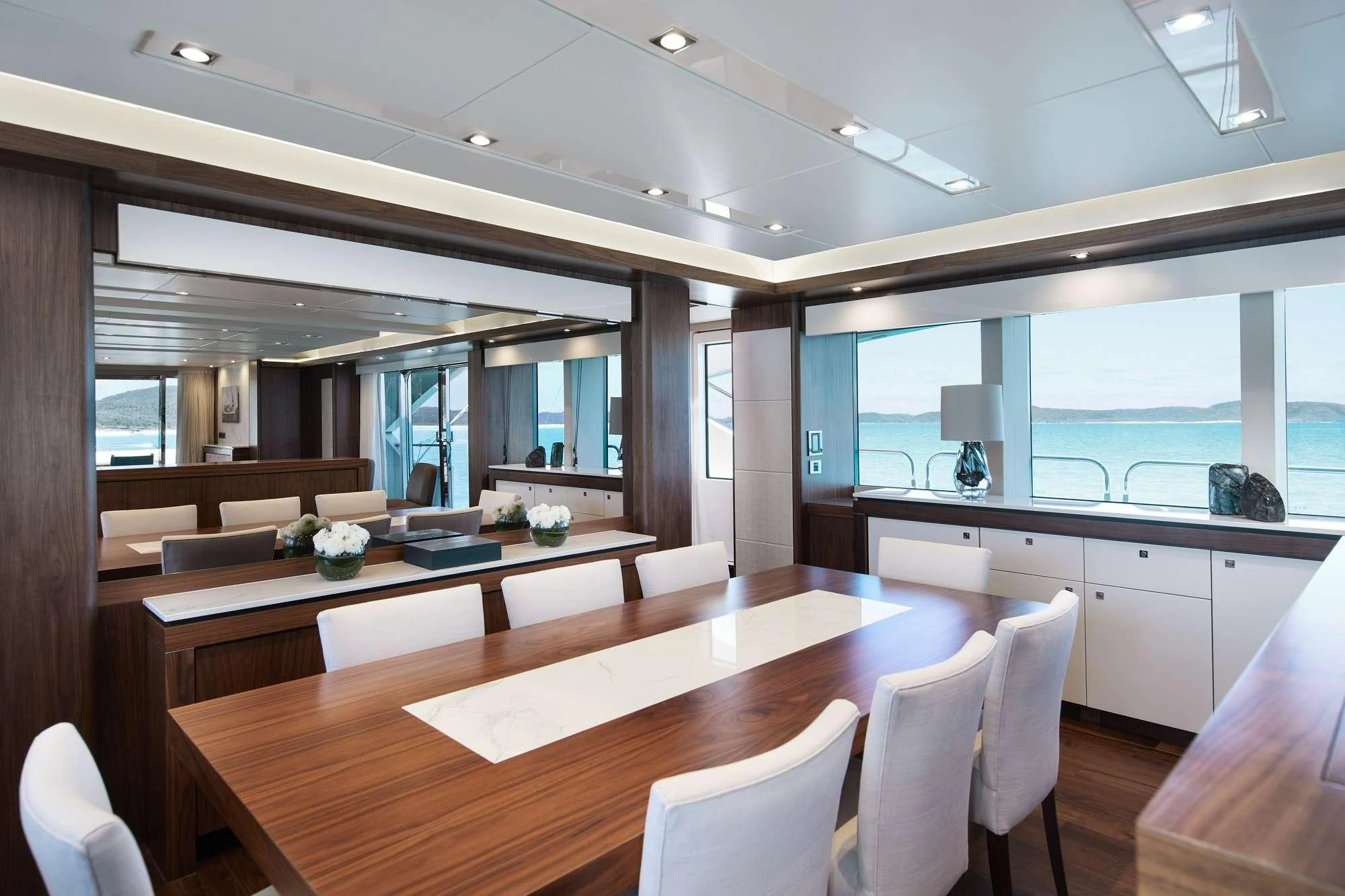 a room with a table chairs and a window aboard GEORGE P Yacht for Charter