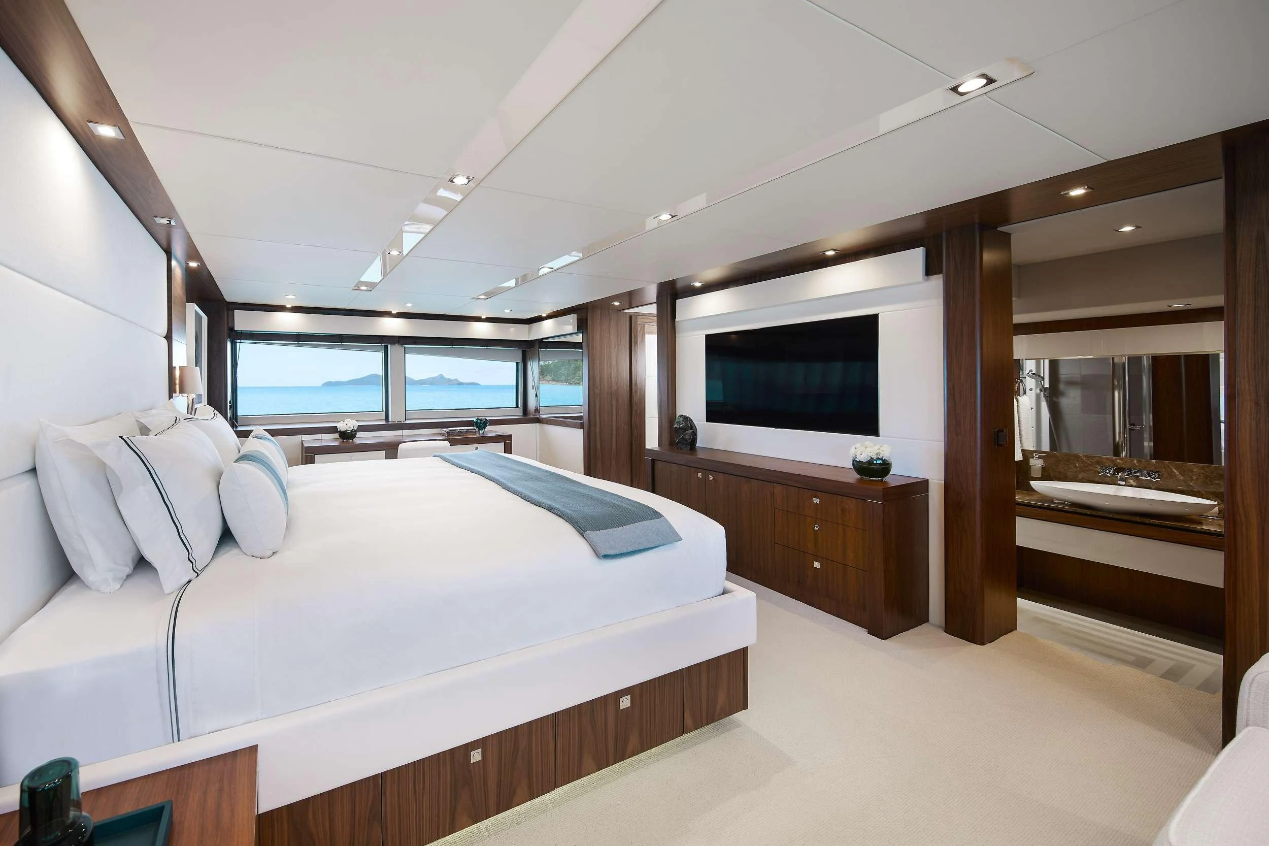 a room with a bed and a television aboard GEORGE P Yacht for Charter