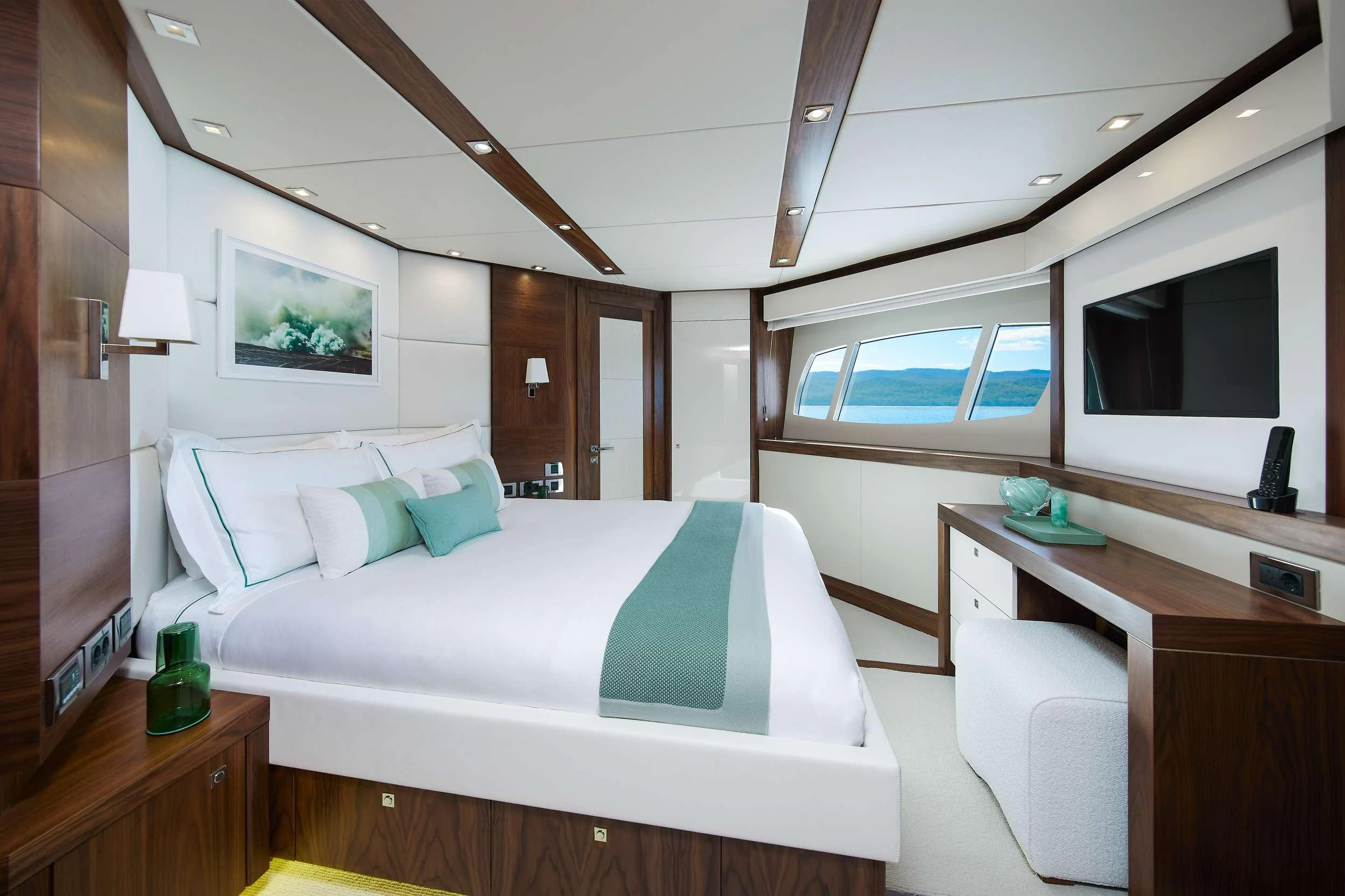a room with a bed and a desk aboard GEORGE P Yacht for Charter