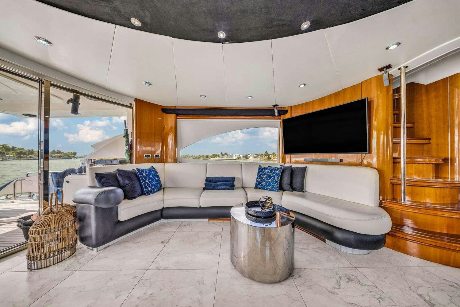 a living room with a large glass window aboard SO WHAT WHO CARES Yacht for Charter