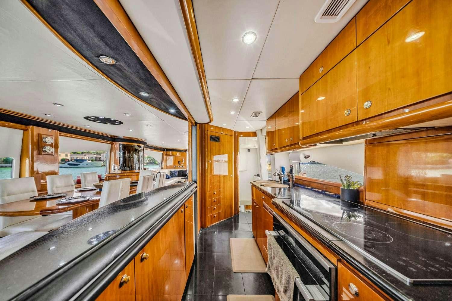 a kitchen with wooden cabinets aboard SO WHAT WHO CARES Yacht for Charter
