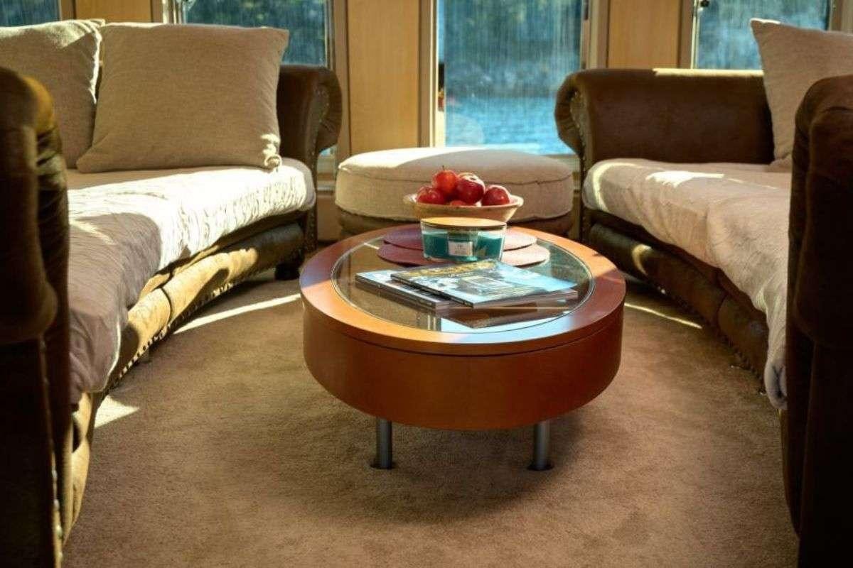 a living room with couches and a coffee table aboard MARSHALL Yacht for Charter