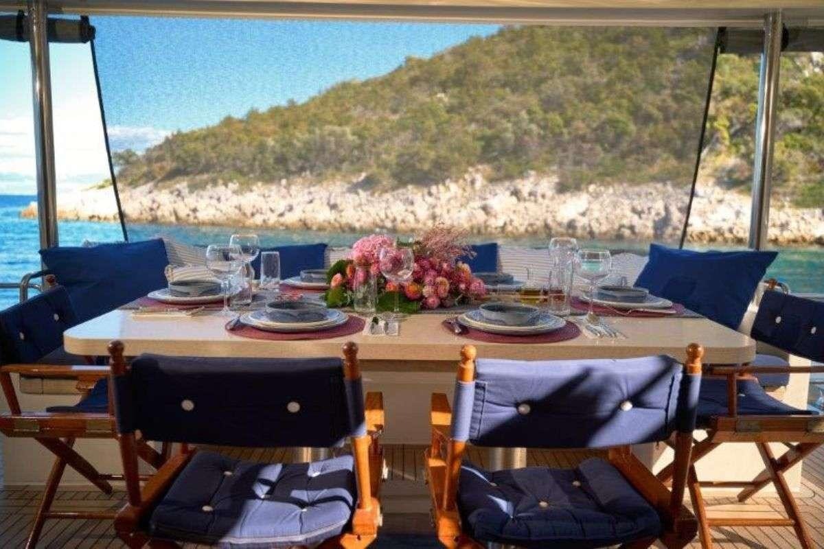 a table set for a dinner on a boat aboard MARSHALL Yacht for Charter