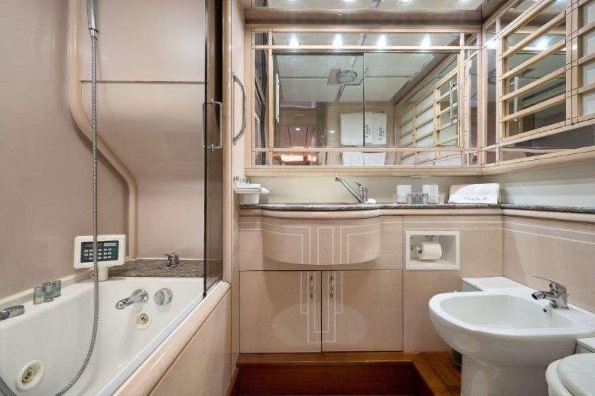 a bathroom with a tub sink and a sink aboard MARSHALL Yacht for Charter