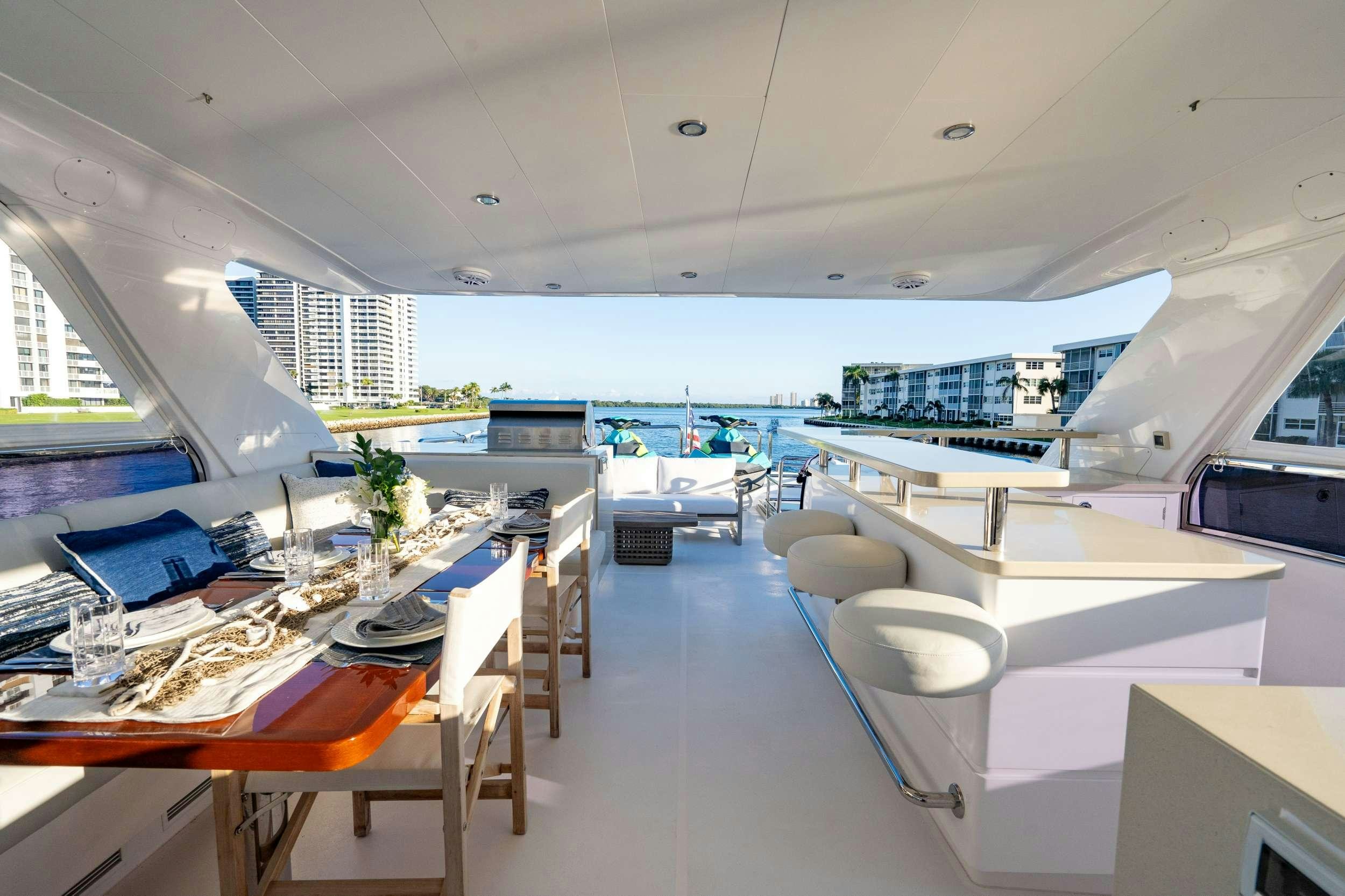 a room with a view of the ocean and the deck aboard PILOT LOUNGE Yacht for Charter