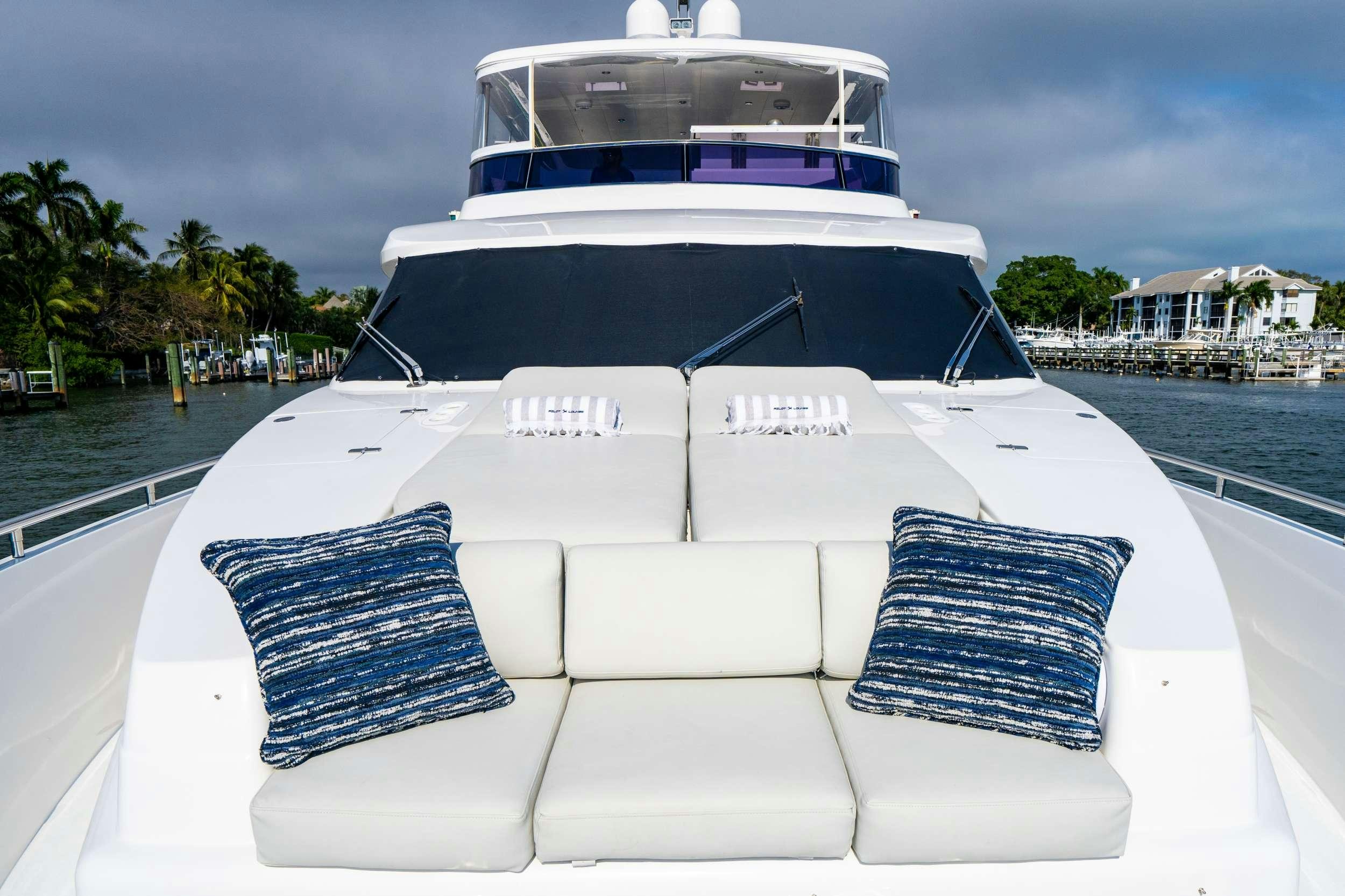 a white boat on a dock aboard PILOT LOUNGE Yacht for Charter