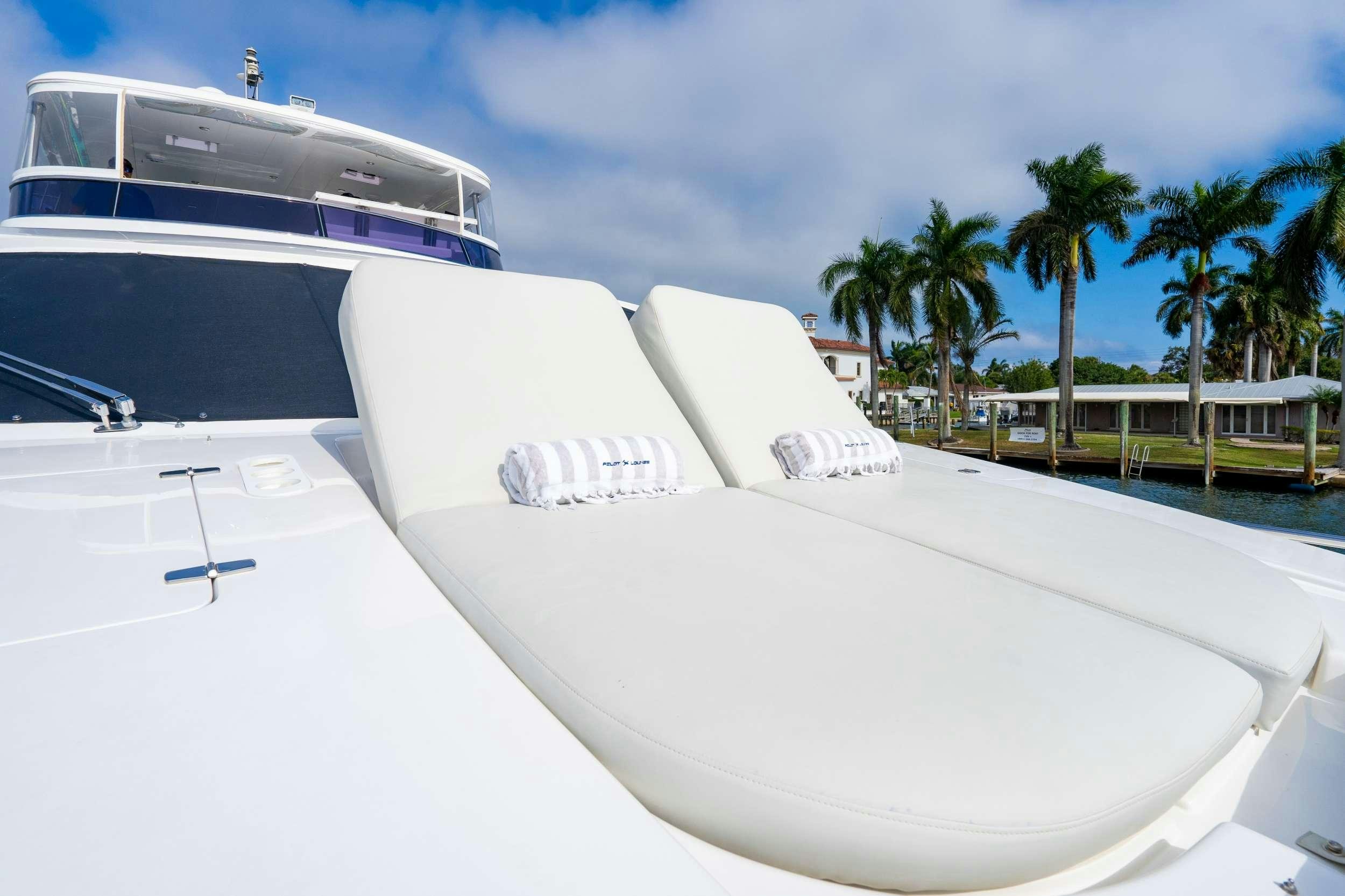 a white boat on a beach aboard PILOT LOUNGE Yacht for Charter
