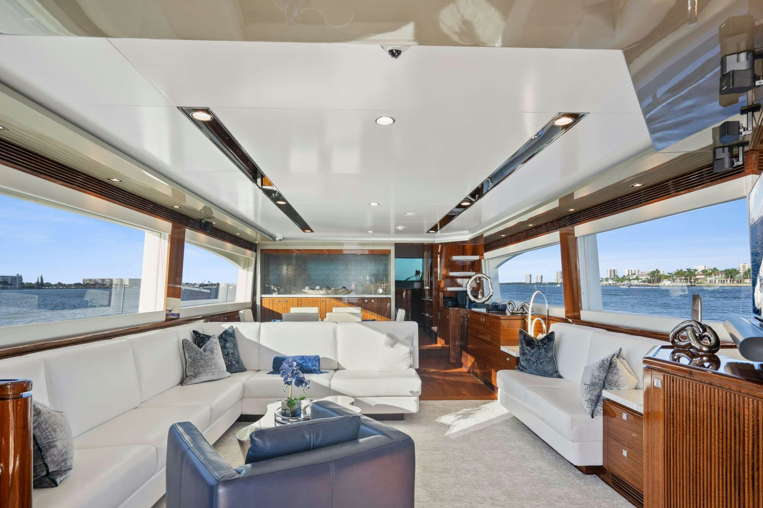 a living room with a large window aboard PILOT LOUNGE Yacht for Charter