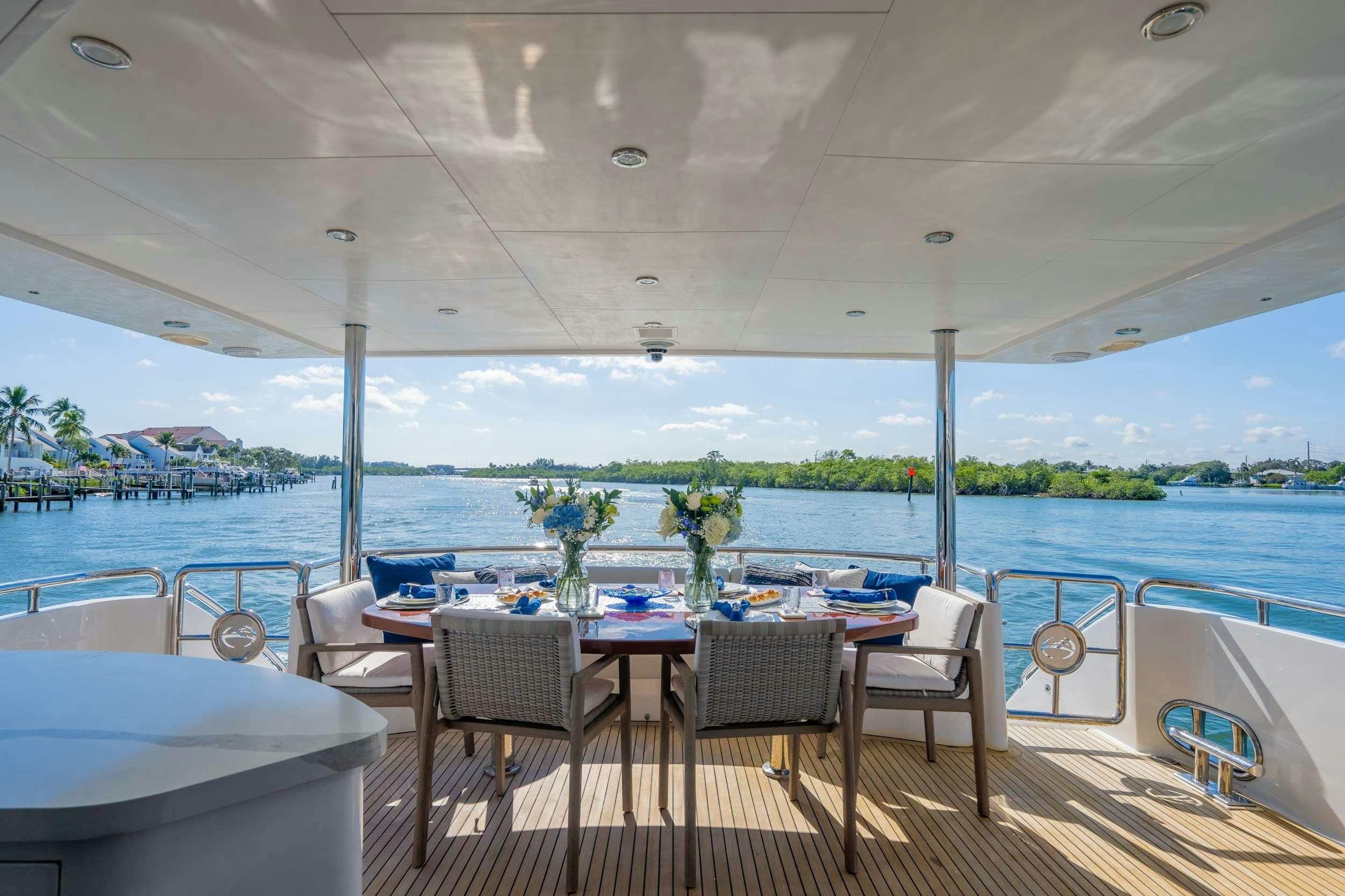 a table and chairs on a deck aboard PILOT LOUNGE Yacht for Charter