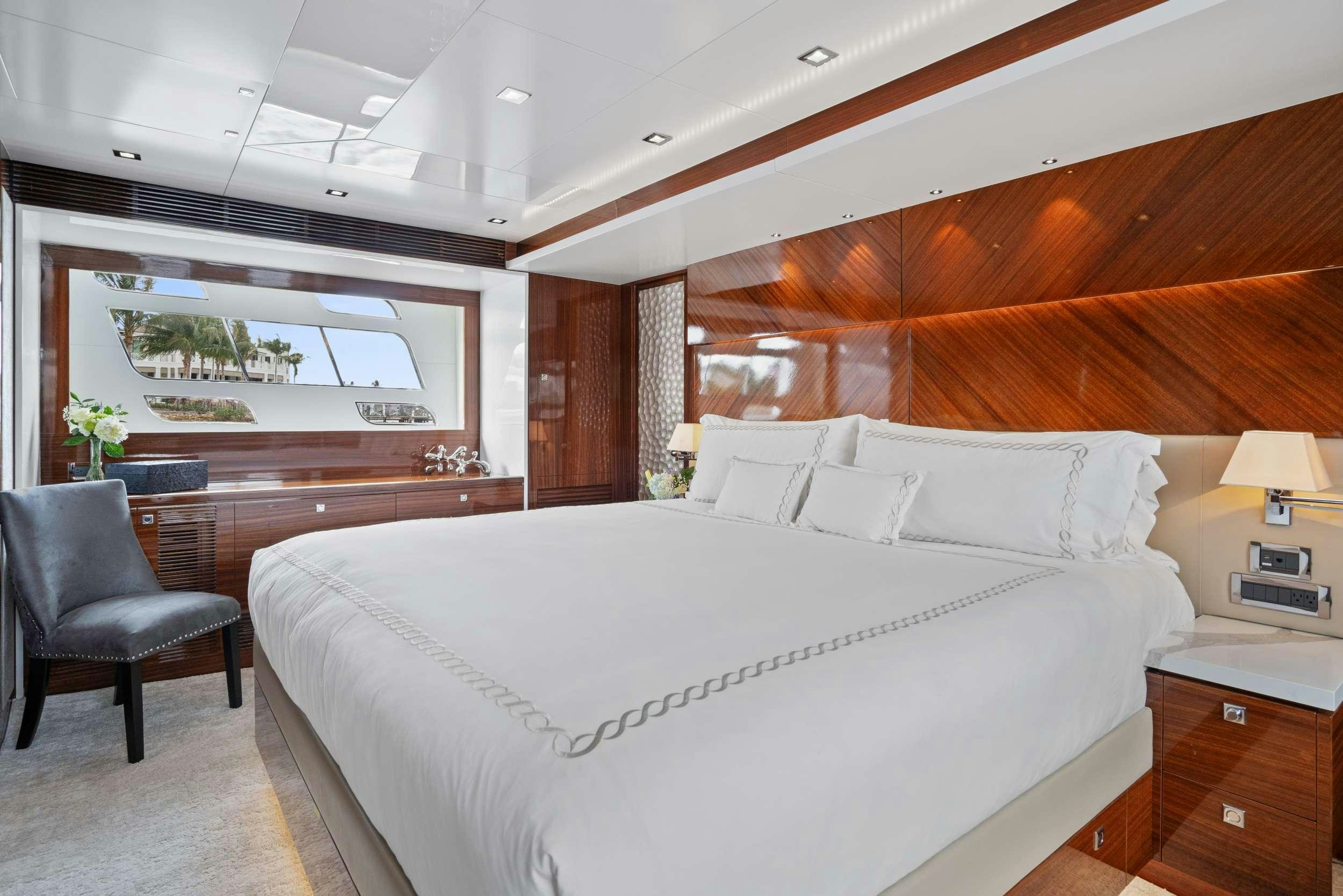 a bed with a chair and a desk in a room aboard PILOT LOUNGE Yacht for Charter