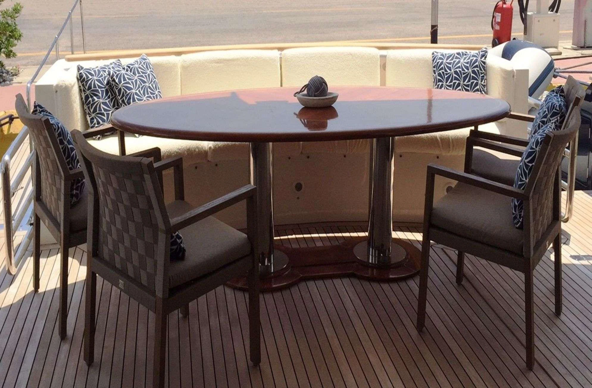 a table and chairs on a deck aboard ATALANTI Yacht for Charter