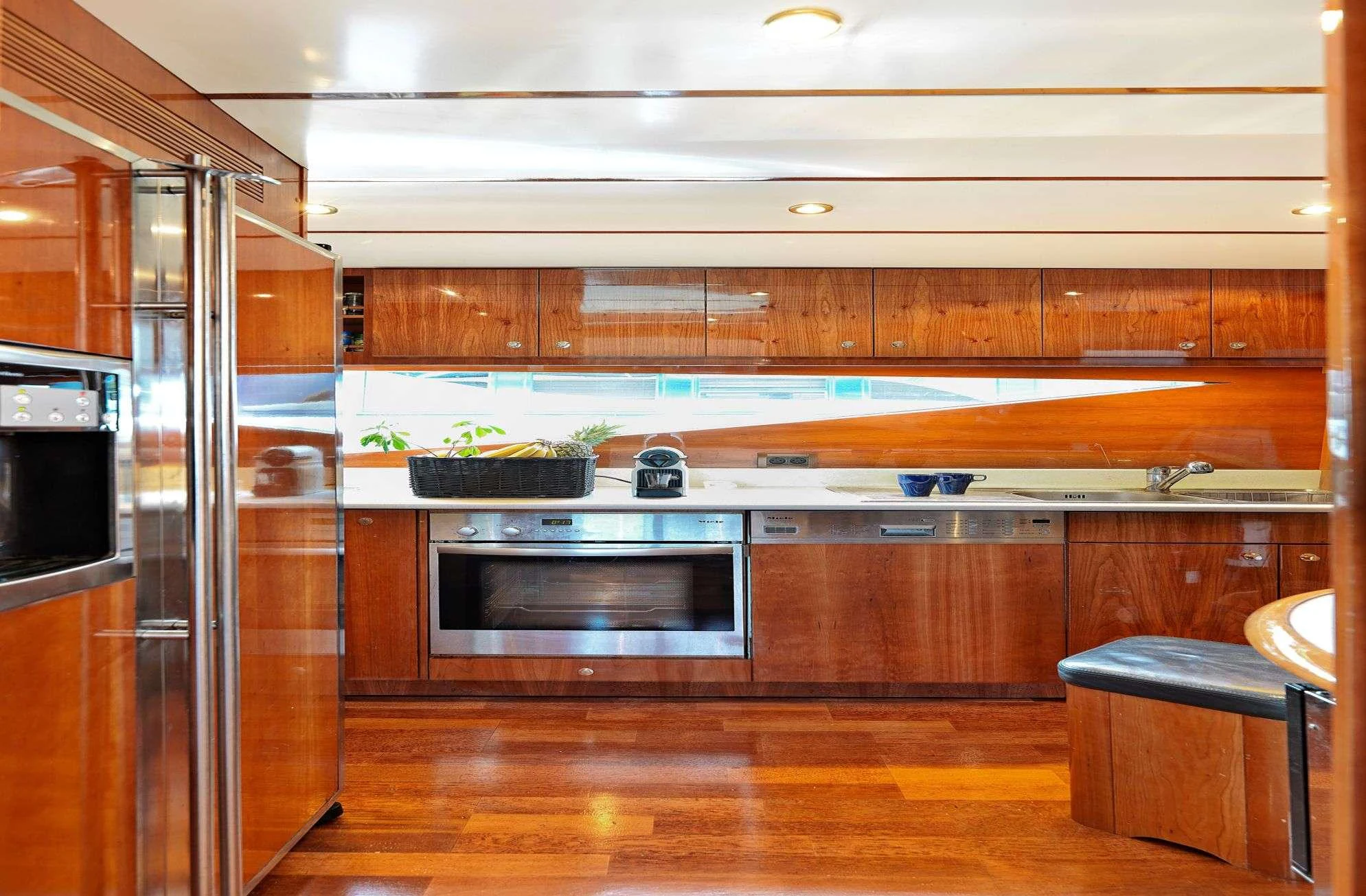 a kitchen with wooden cabinets aboard ATALANTI Yacht for Charter