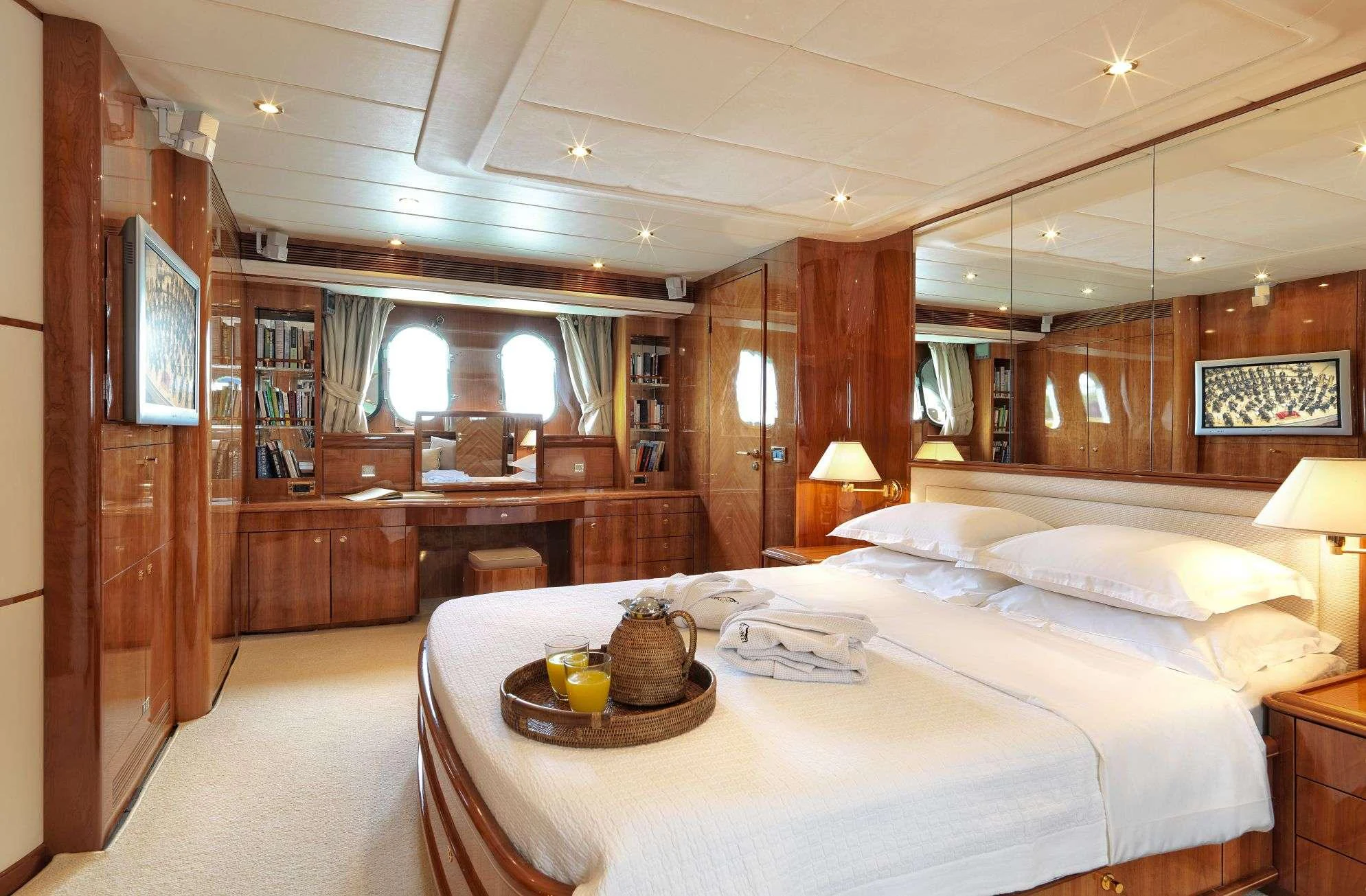a room with a bed and a table aboard ATALANTI Yacht for Charter