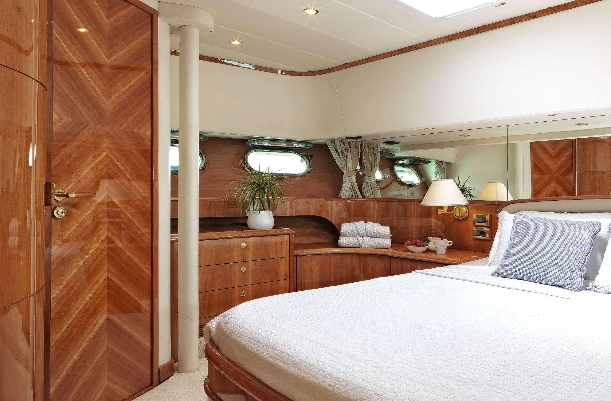 a bedroom with a bed and a wood door aboard ATALANTI Yacht for Charter