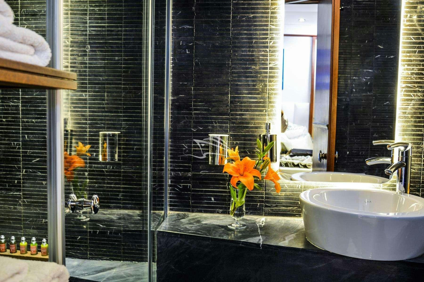 a bathroom with a glass shower aboard PAPA JOE Yacht for Charter