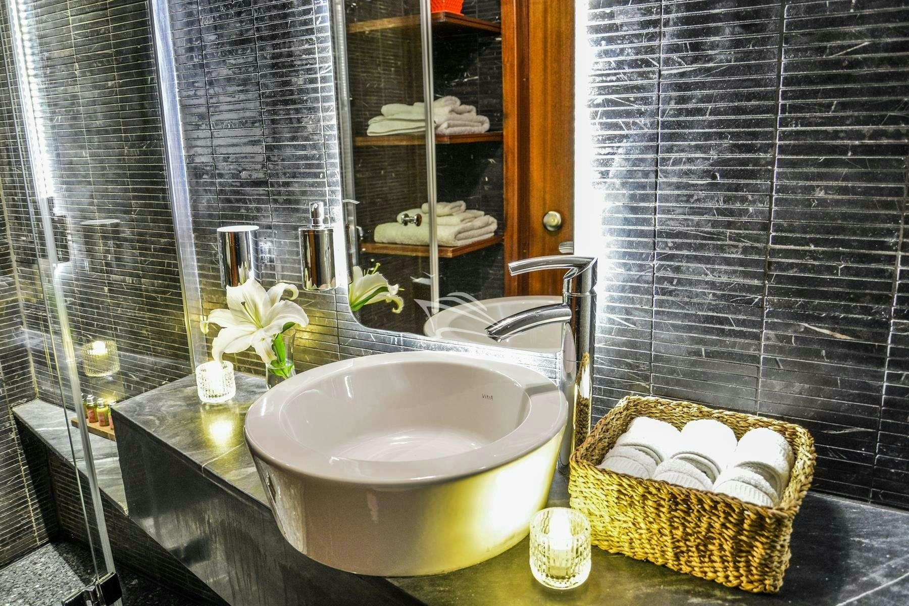 a bathroom with a sink and a mirror aboard PAPA JOE Yacht for Charter