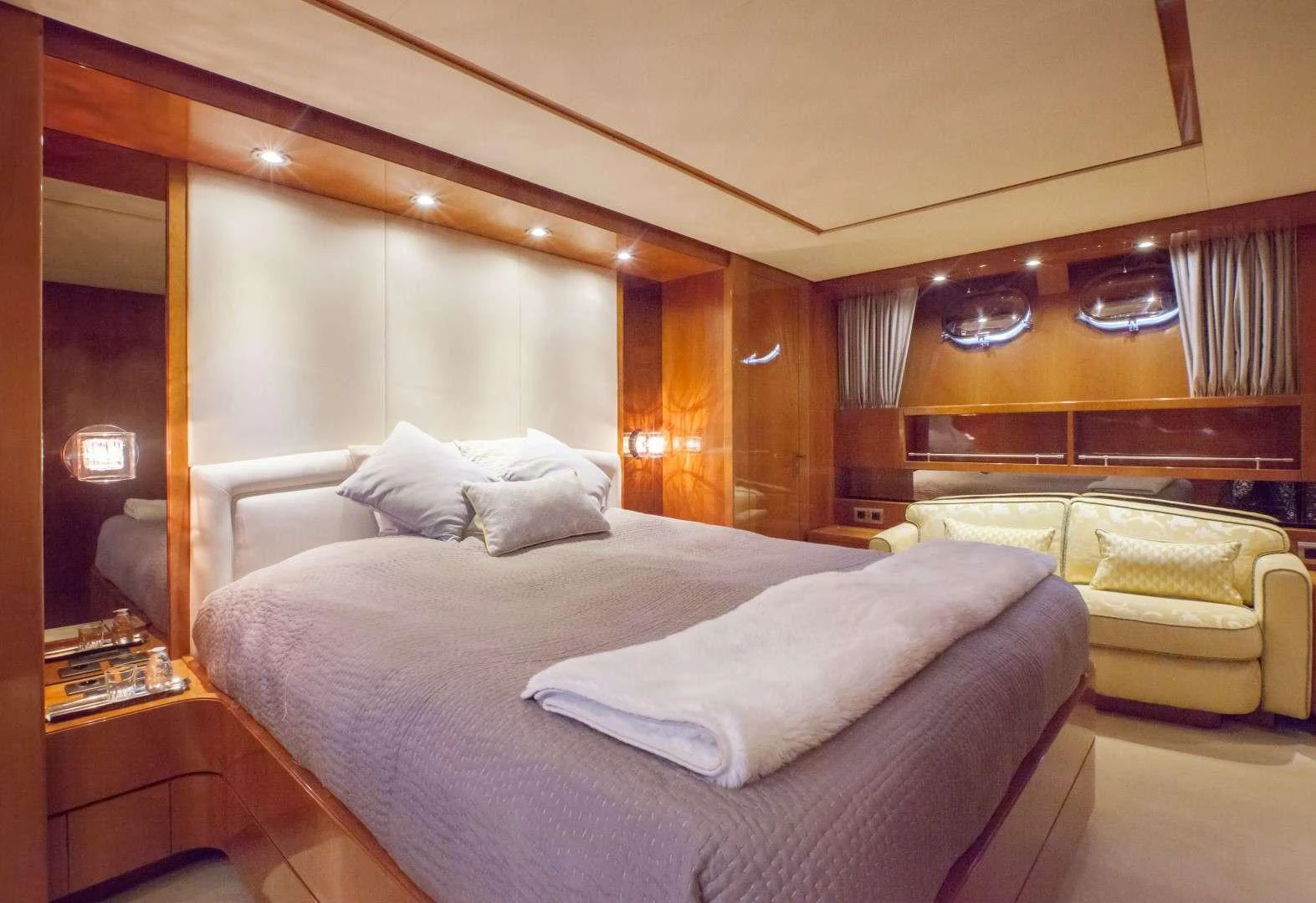 a bedroom with a bed and a couch aboard SOLAL Yacht for Charter