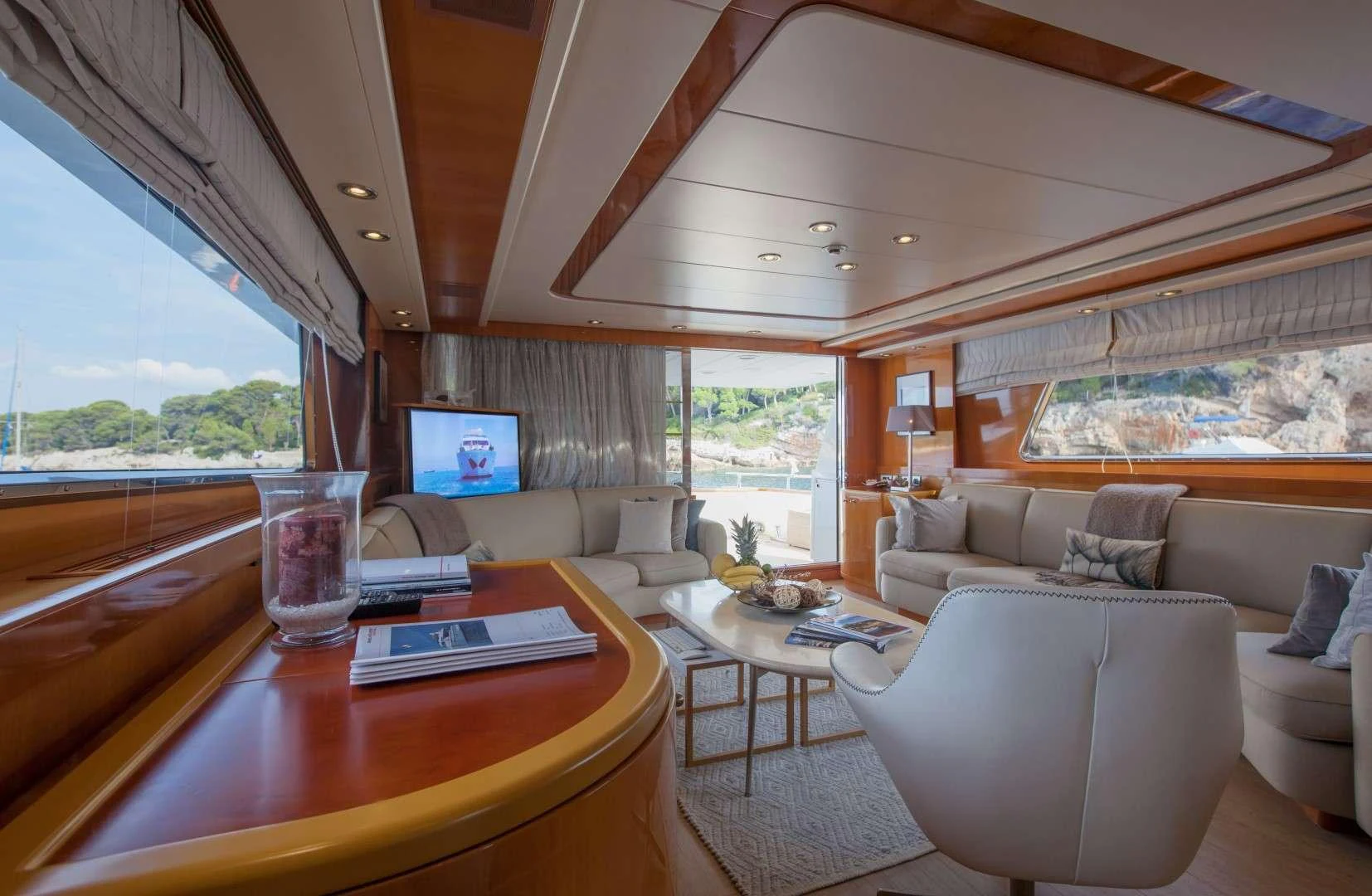 a living room with a table and couches aboard SOLAL Yacht for Charter