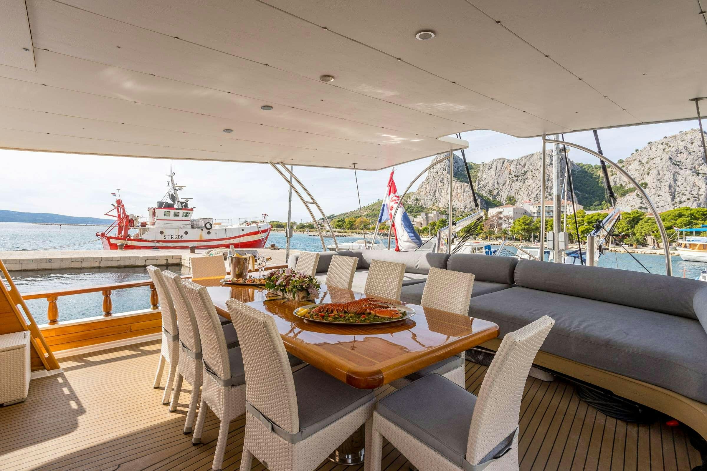 a table and chairs on a boat aboard ANĐEO Yacht for Charter