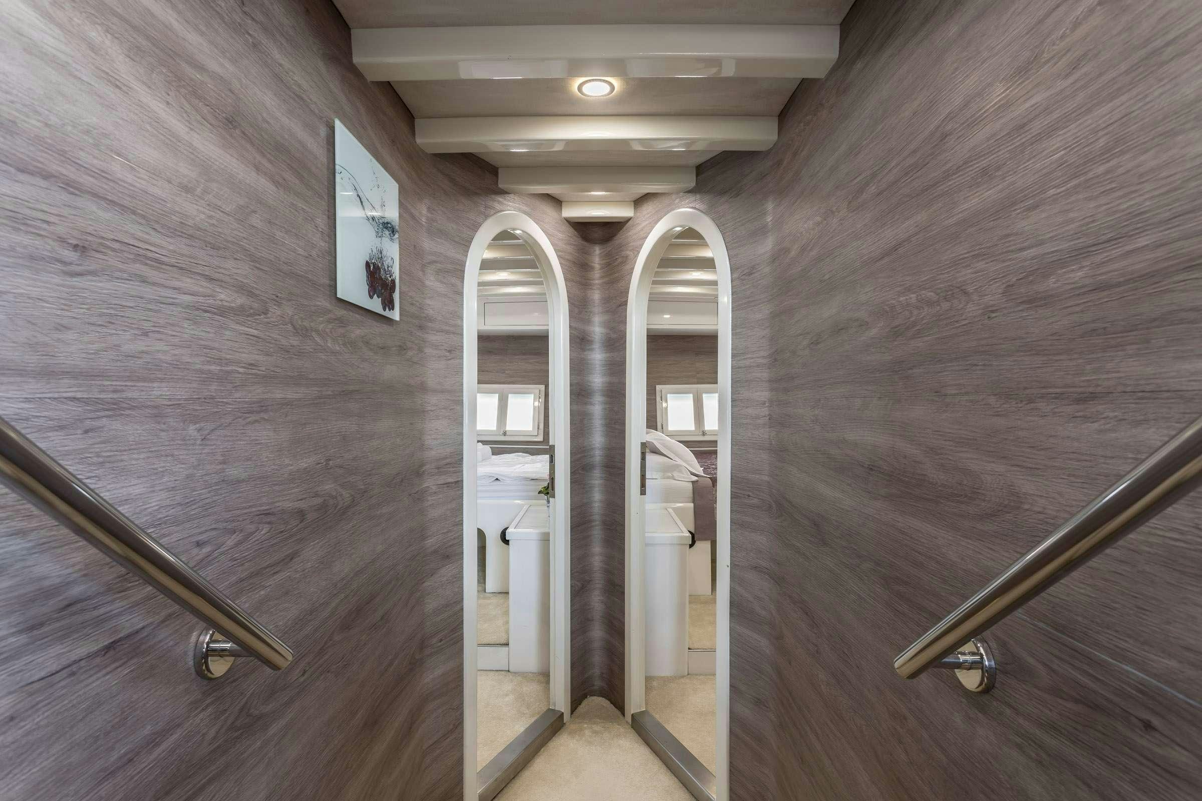 a room with a door and a mirror on the wall aboard ANĐEO Yacht for Charter