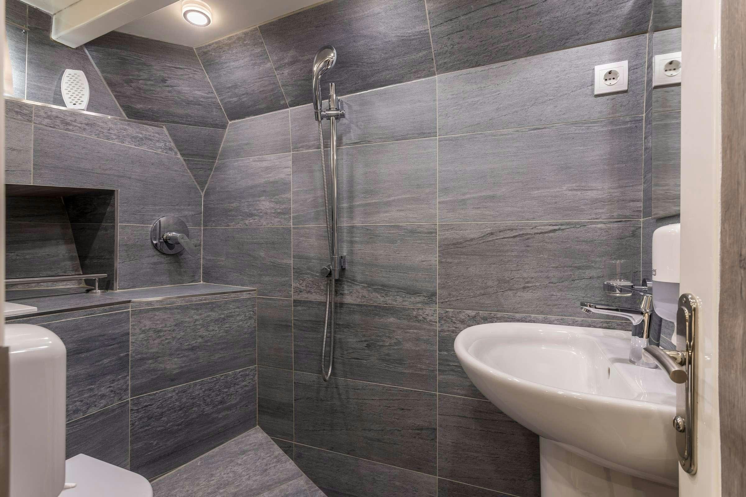 a bathroom with a glass shower aboard ANĐEO Yacht for Charter