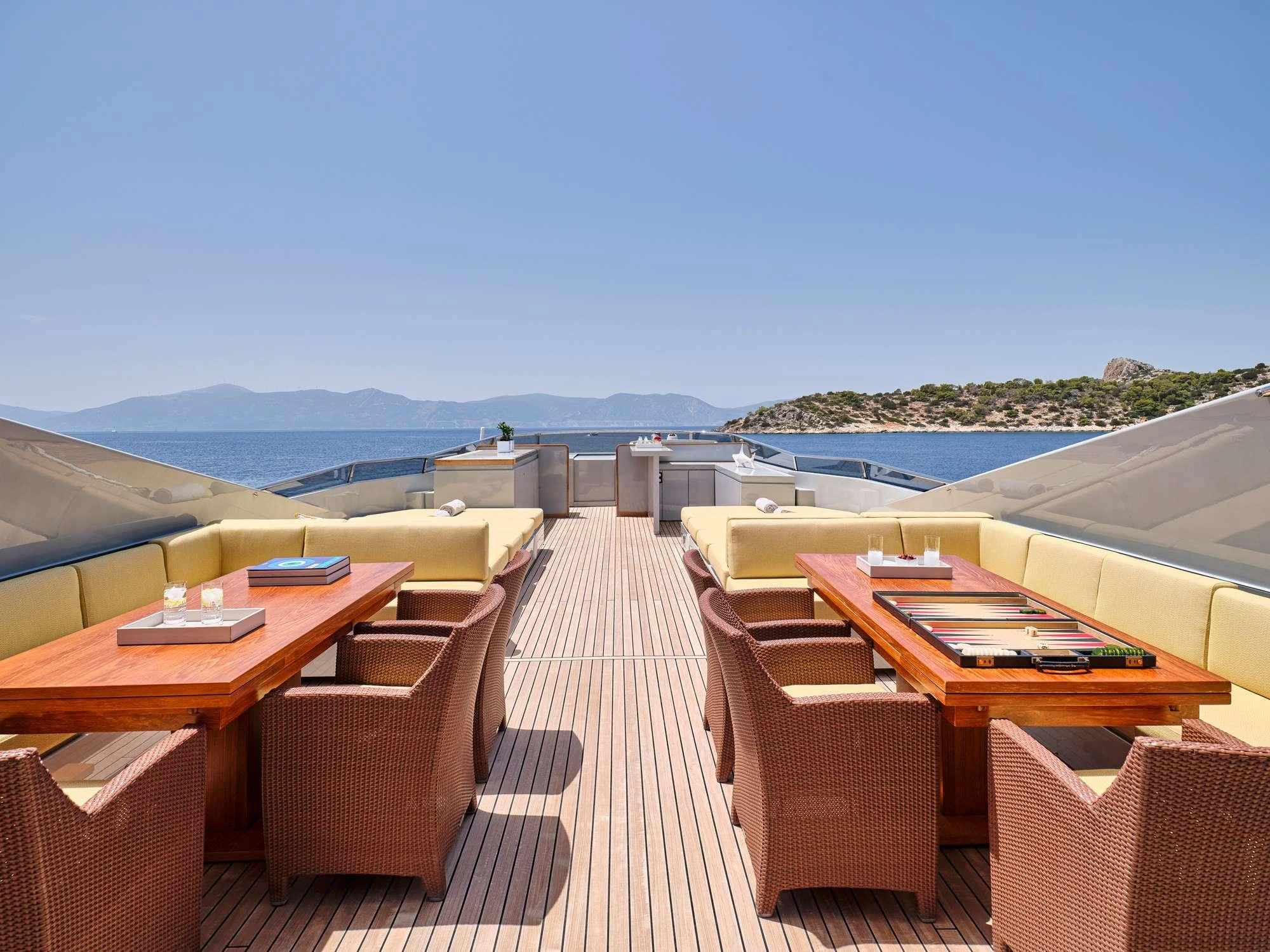 a deck with a view of the ocean and a large city aboard KINTARO Yacht for Charter