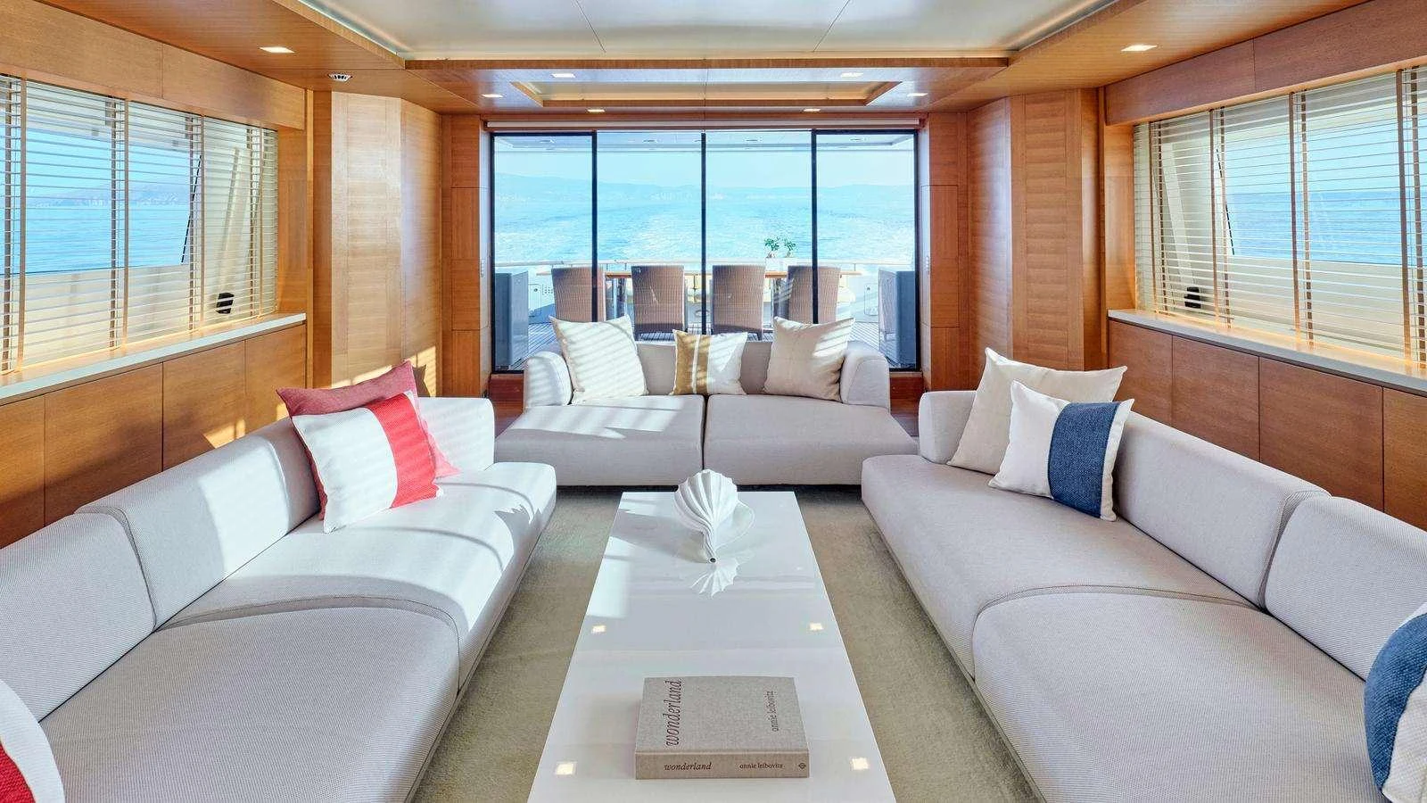 a living room with couches and a table aboard KINTARO Yacht for Charter
