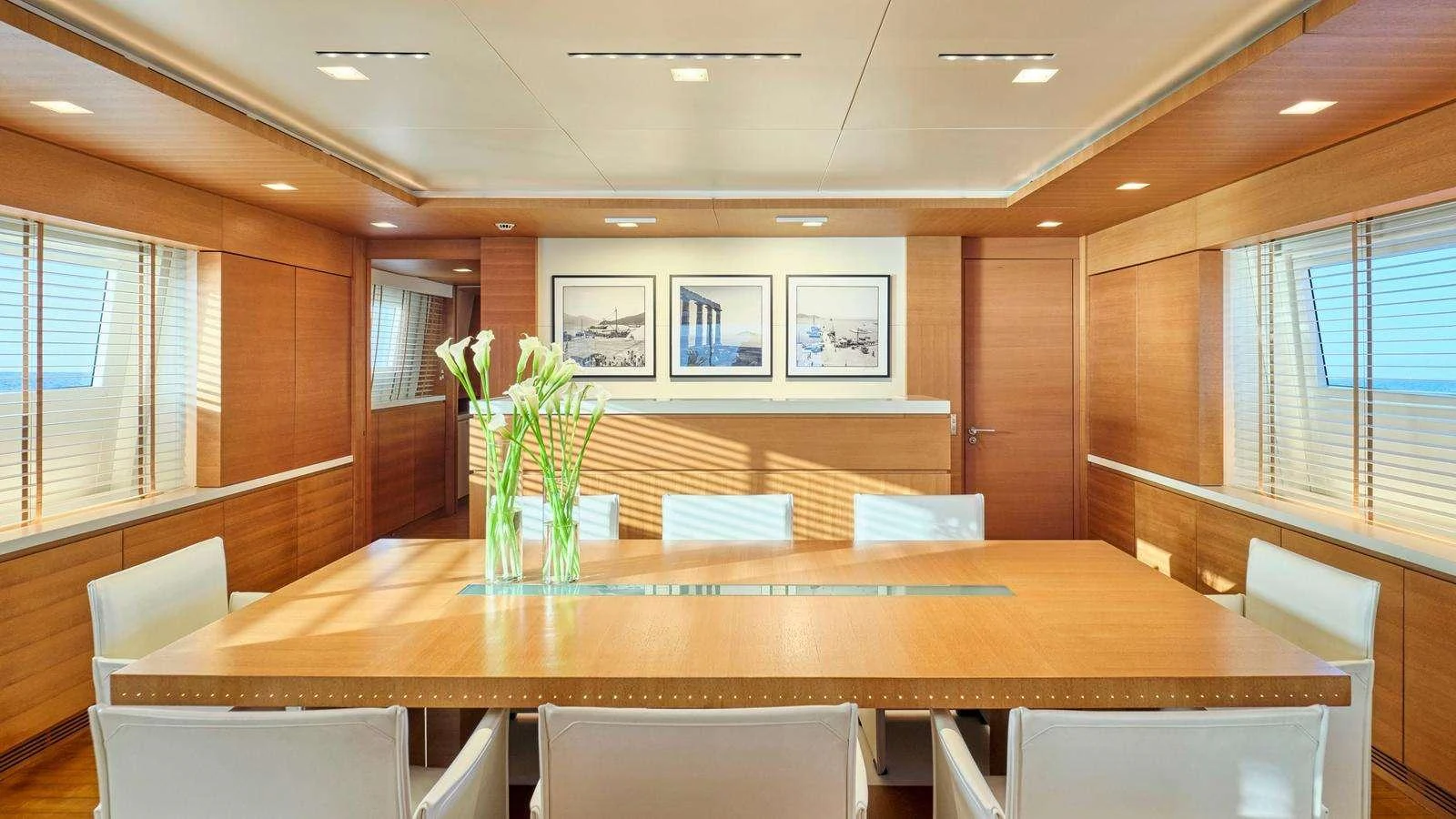 a large conference room with a table and chairs aboard KINTARO Yacht for Charter