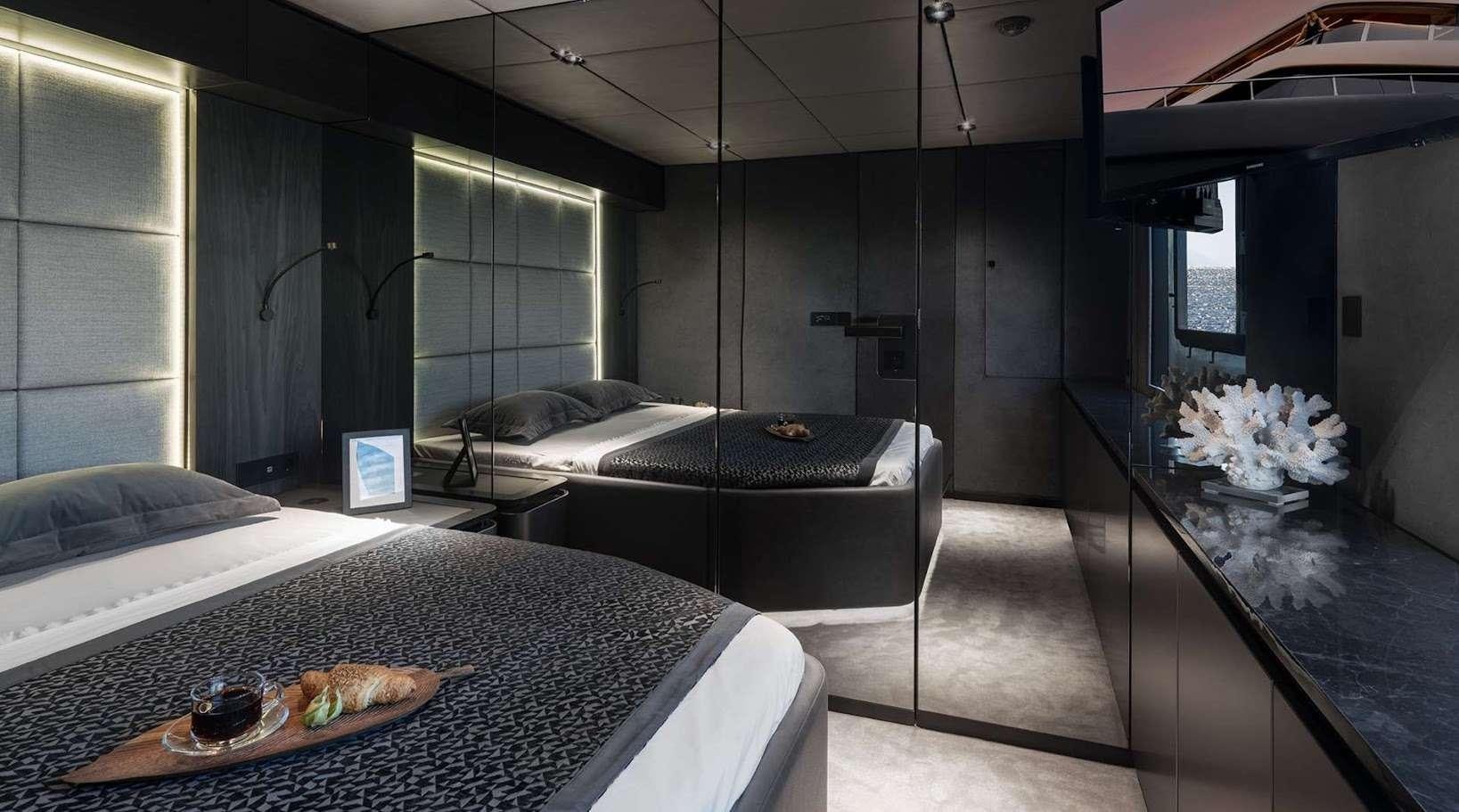 a room with a bed and a table aboard ALTEYA Yacht for Charter