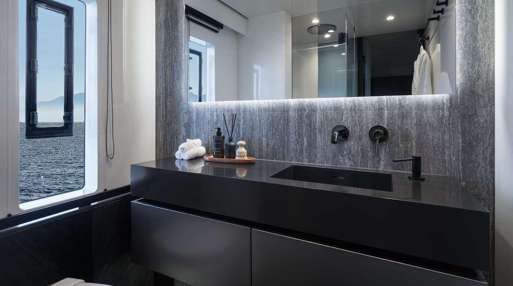 a bathroom with a large mirror aboard ALTEYA Yacht for Charter
