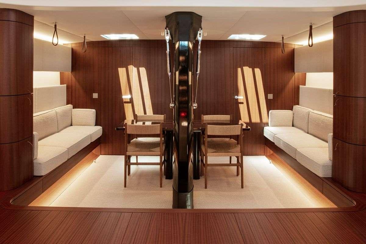 a room with a chair and a table and a couch aboard CALABASH Yacht for Charter