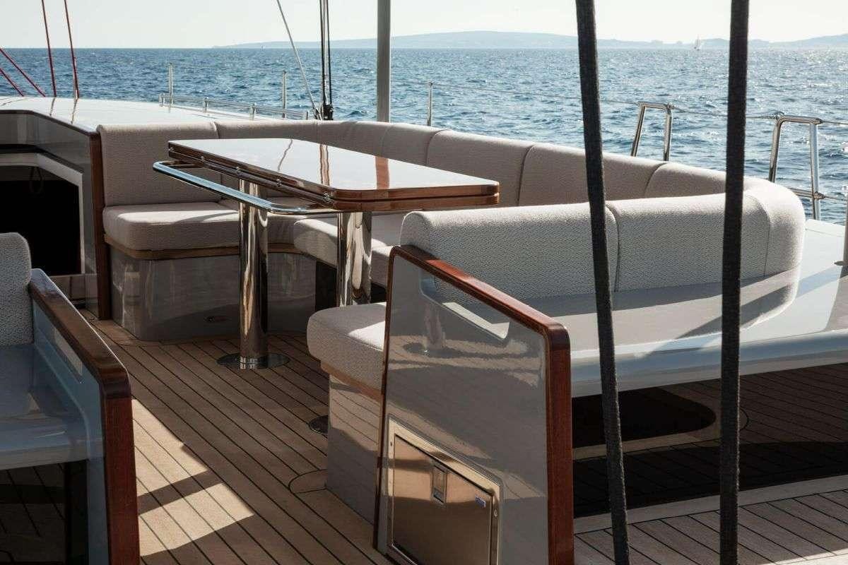 a table and chairs on a deck aboard CALABASH Yacht for Charter